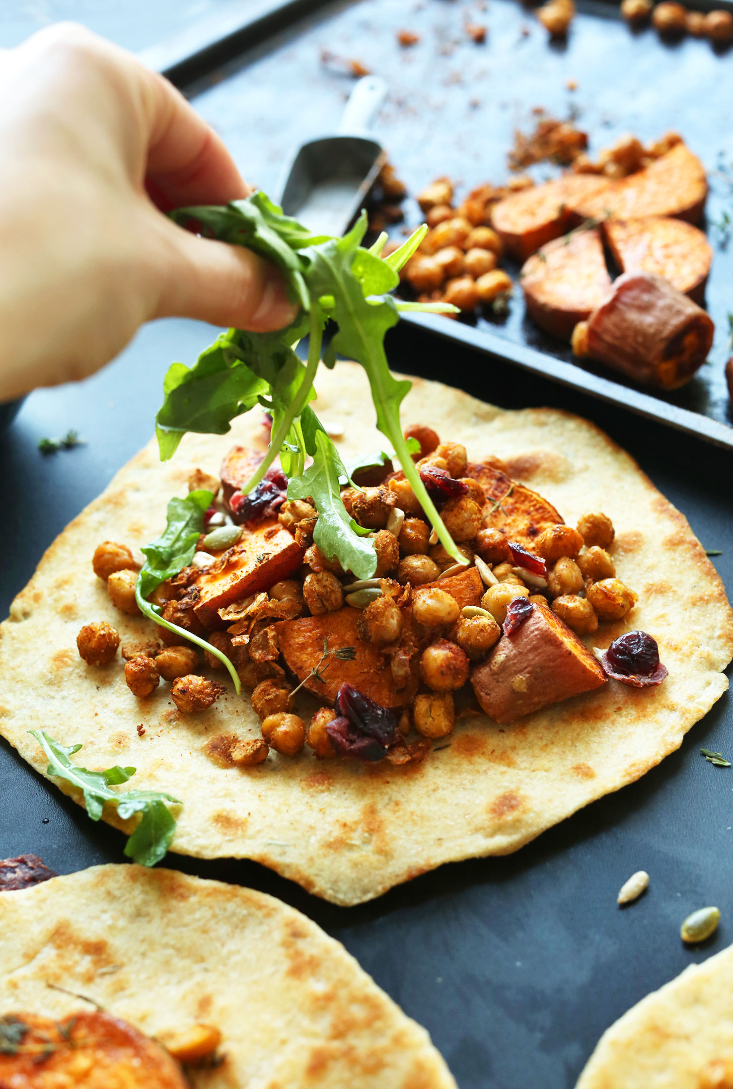 Adding fresh arugula to Fall Bounty Thanksgiving Wraps