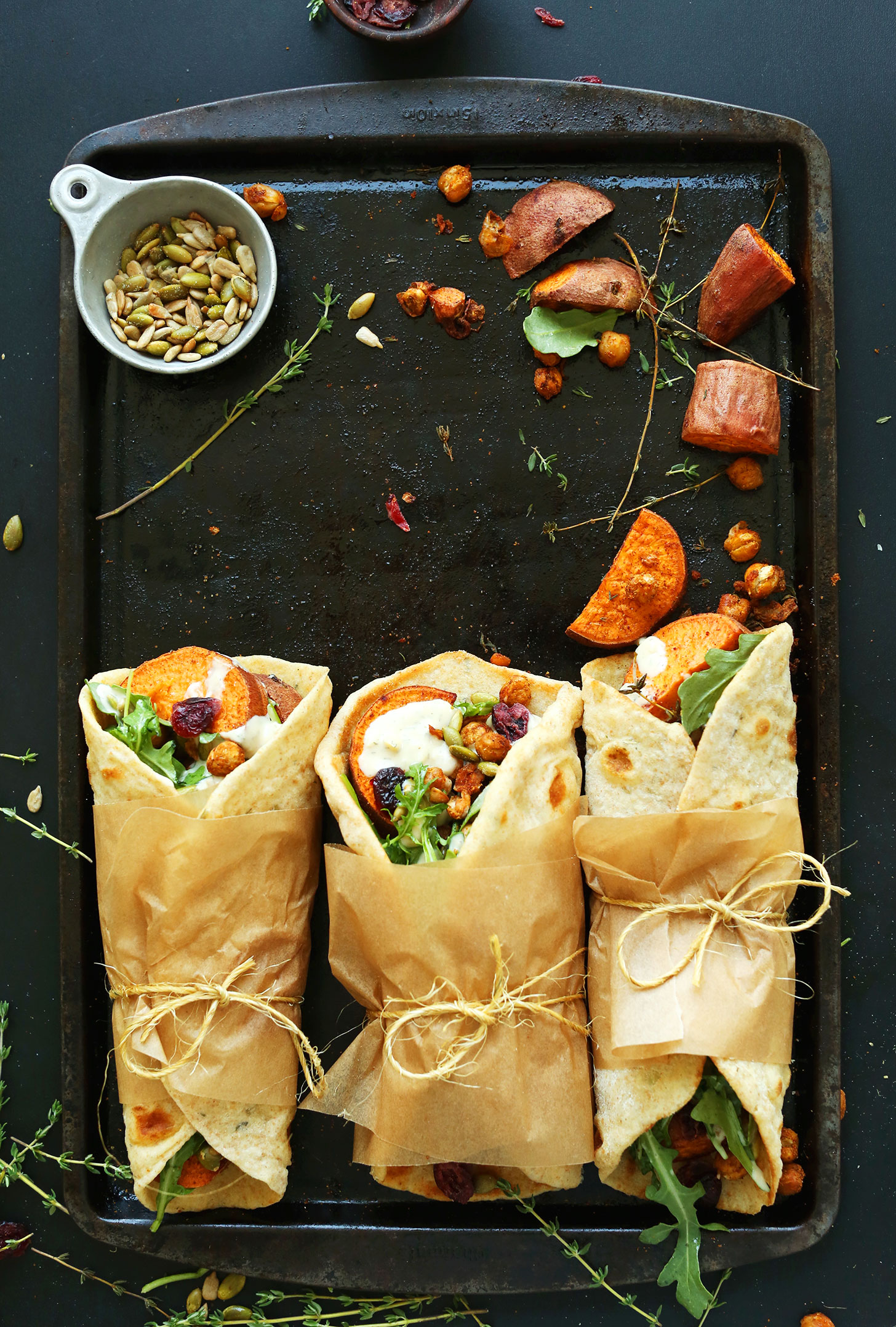 Baking sheet with Fall Bounty Thanksgiving Wraps tied with parchment paper and twine