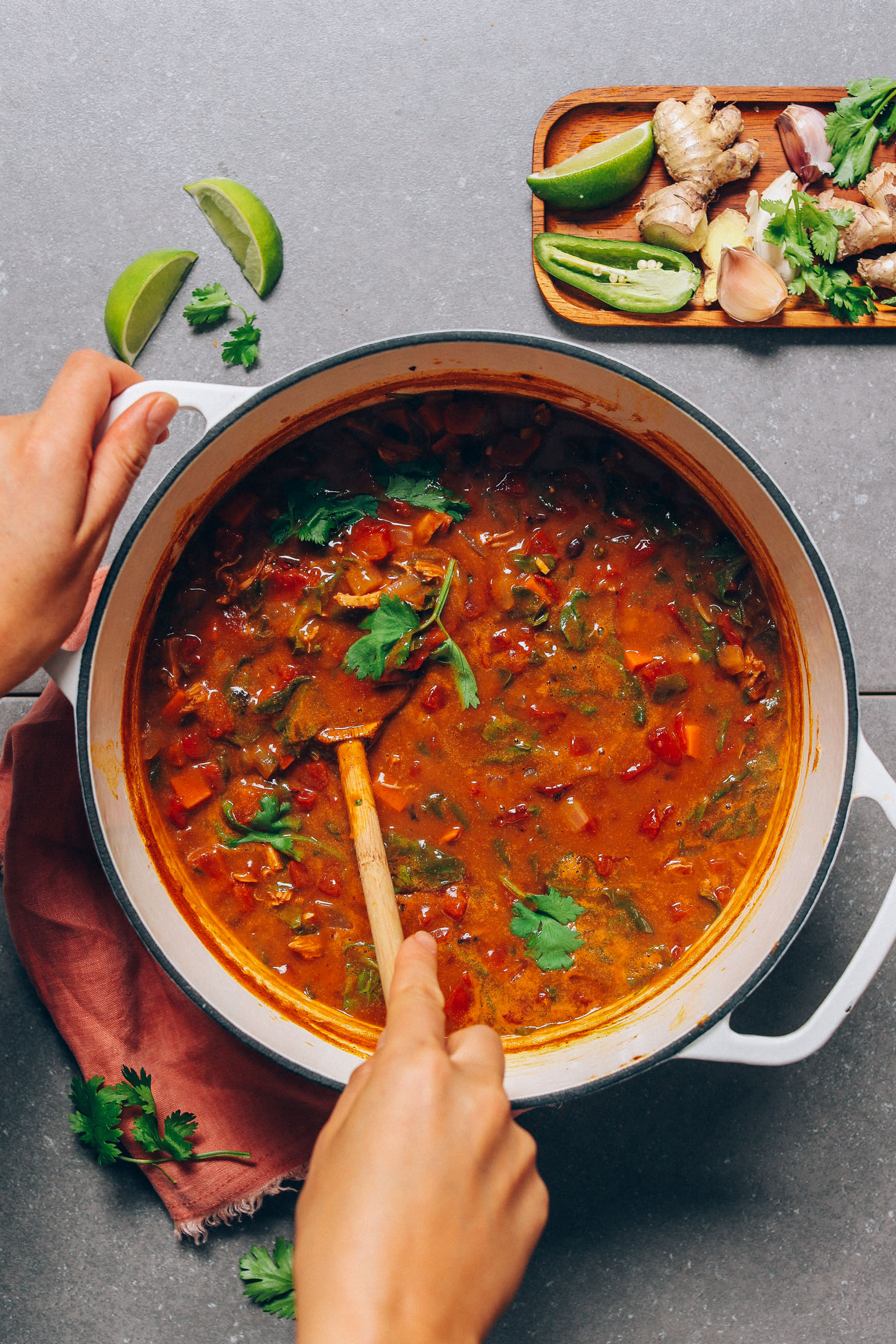 Stirring a pot of our Black Bean Pumpkin Soup recipe made with a fusion of Thai and classic chili flavor