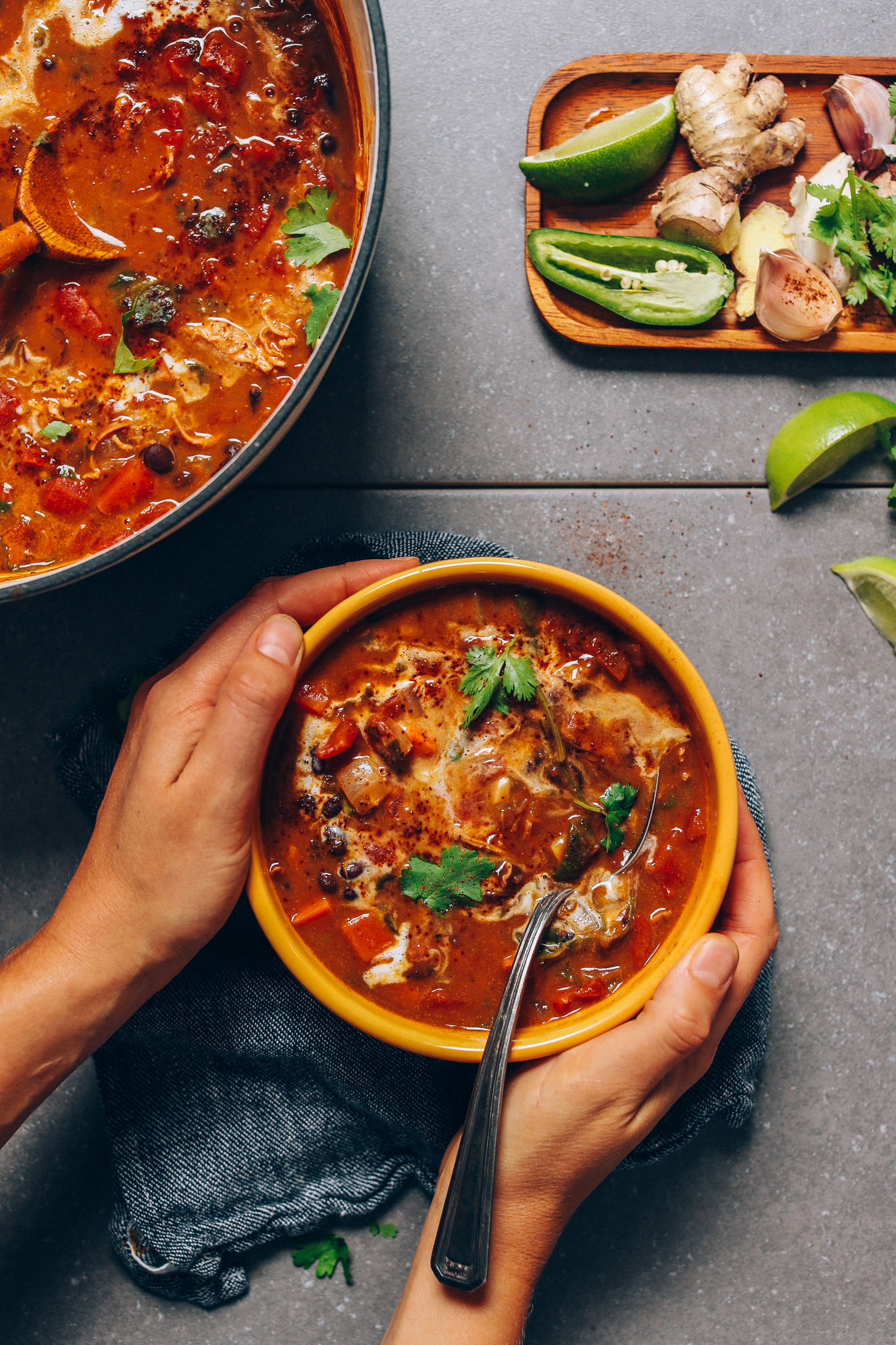 Holding the sides of a bowl of our dairy-free Pumpkin Black Bean Soup recipe