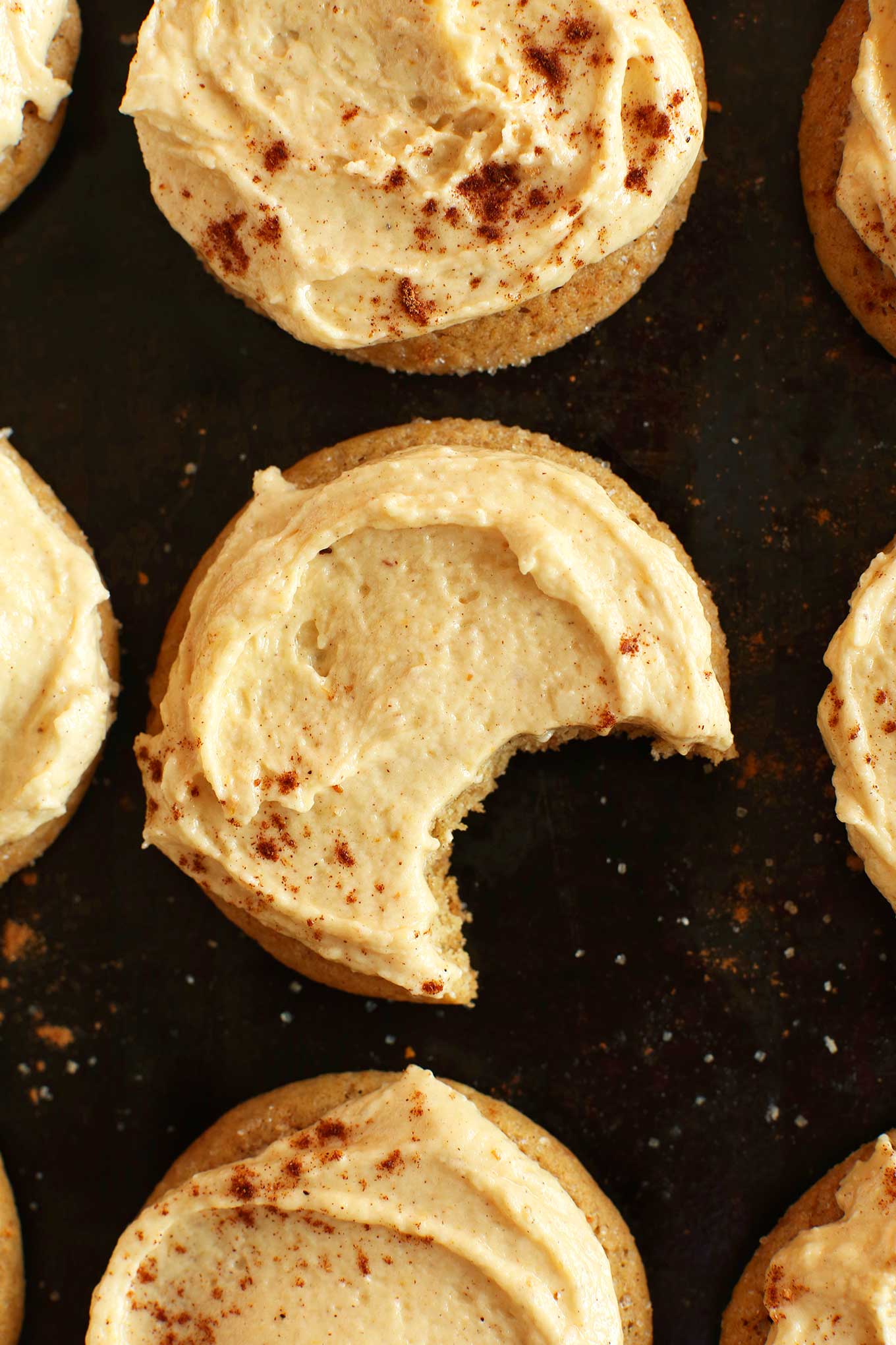 Delicious partially eaten Pumpkin Sugar Cookie alongside the rest of the batch