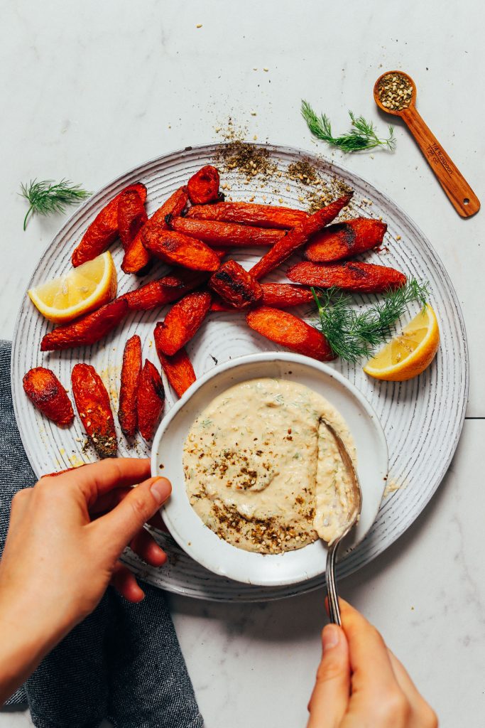 Using a spoon to scoop up Hummus Dill Garlic Sauce