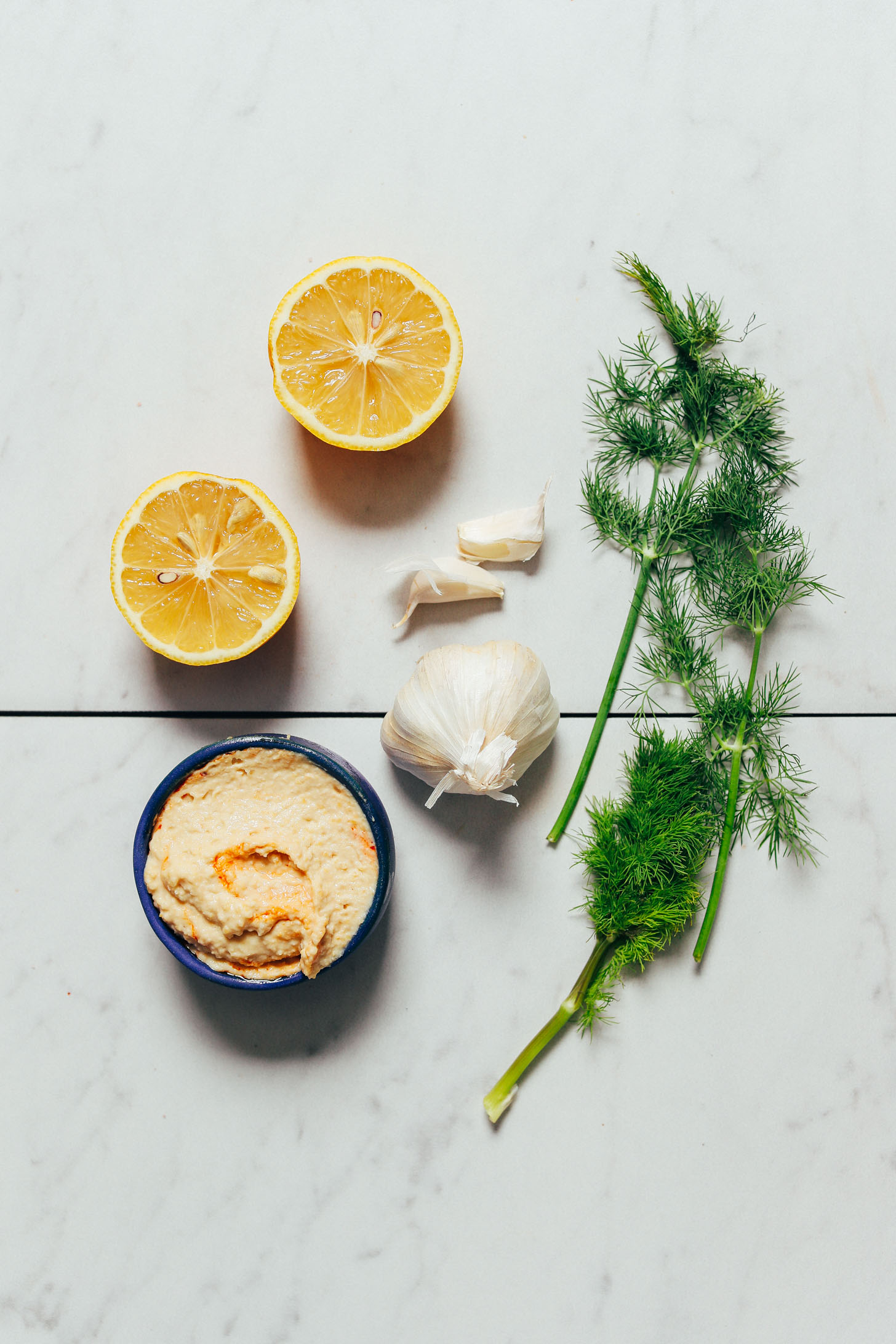 Hummus, garlic, fresh dill, and lemon for making our simple Hummus Garlic Sauce recipe