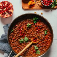 Large skillet filled with a batch of our hearty vegan Lentil Fesenjan recipe