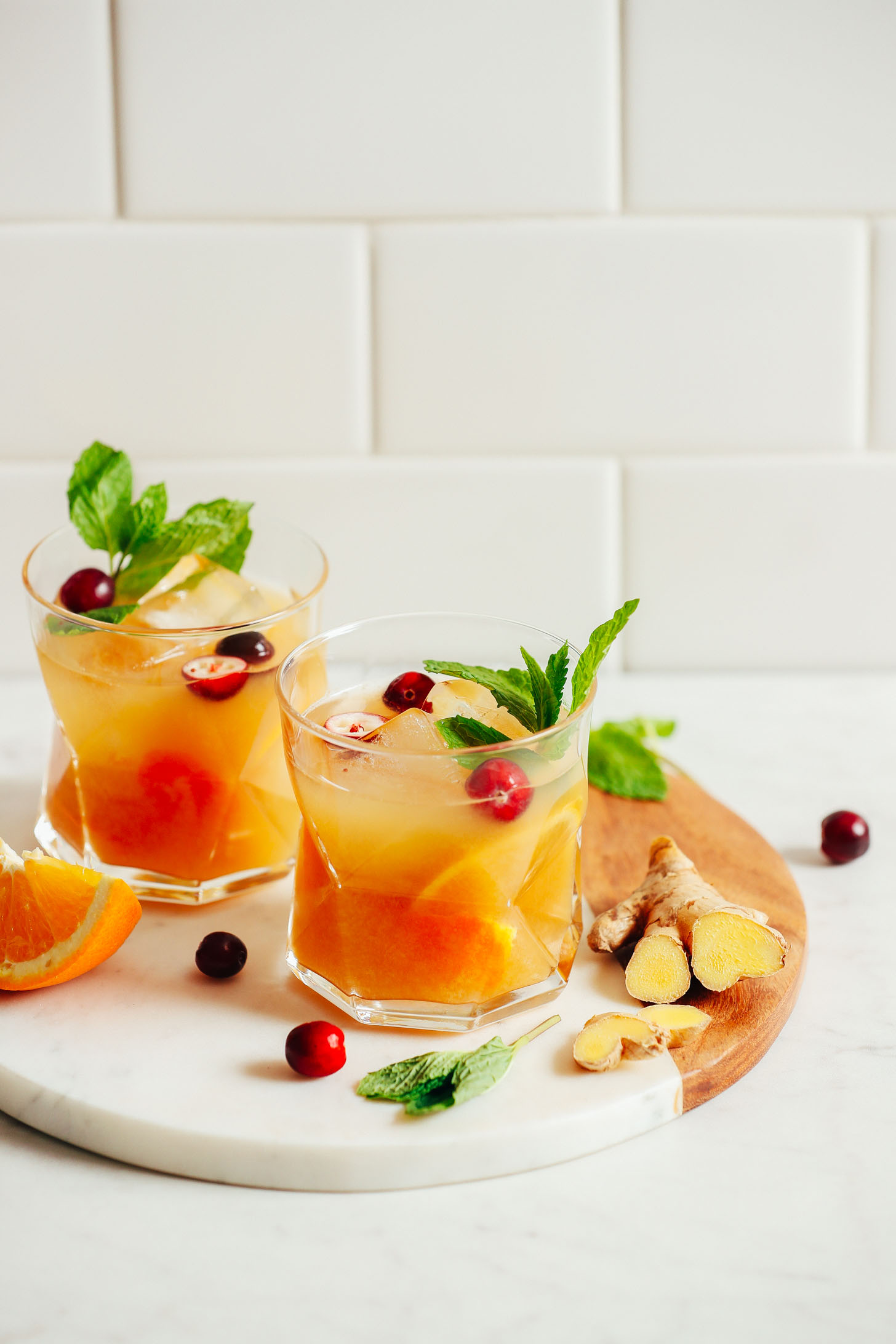 Two glasses of refreshing, naturally sweetened Orange Whiskey Gingers with Mint