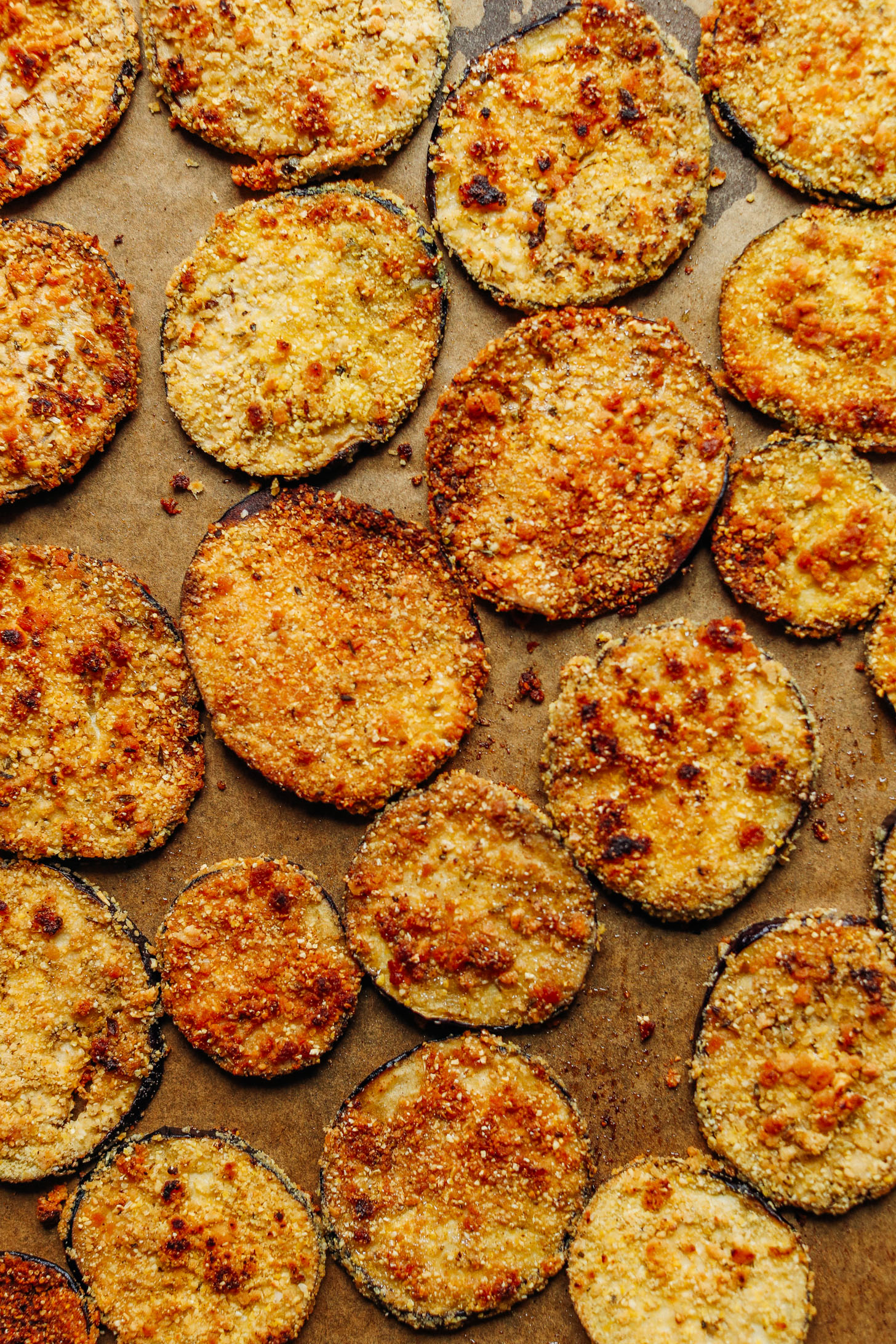 Vegan Gluten-Free Crispy Eggplant Parmesan fresh from the oven on a parchment-lined baking sheet