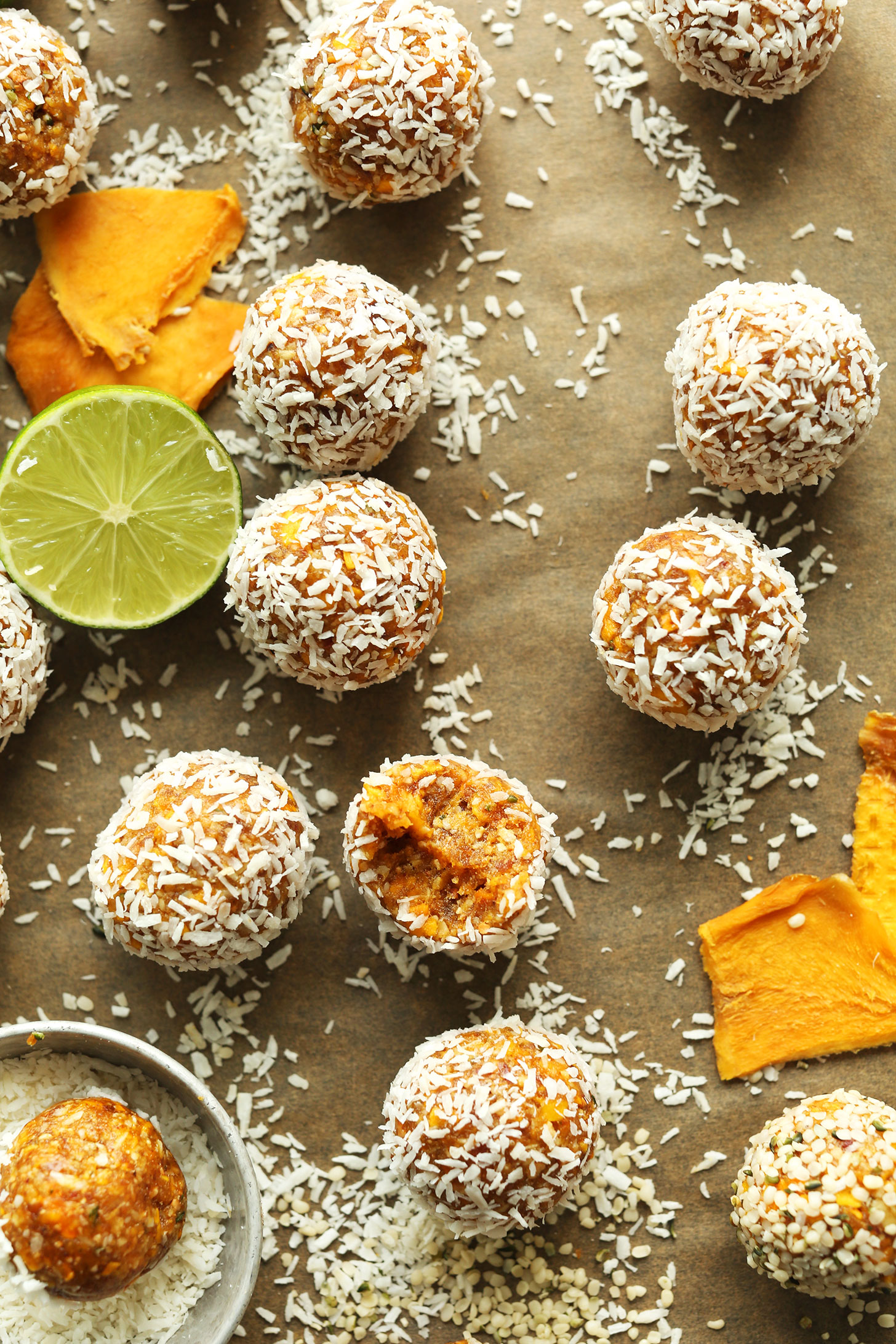 Parchment-lined baking sheet with Dried Mango Energy Bites for a gluten-free vegan snack