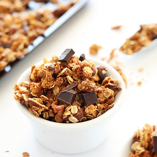 Bowl of Almond Joy Granola topped with dark chocolate pieces