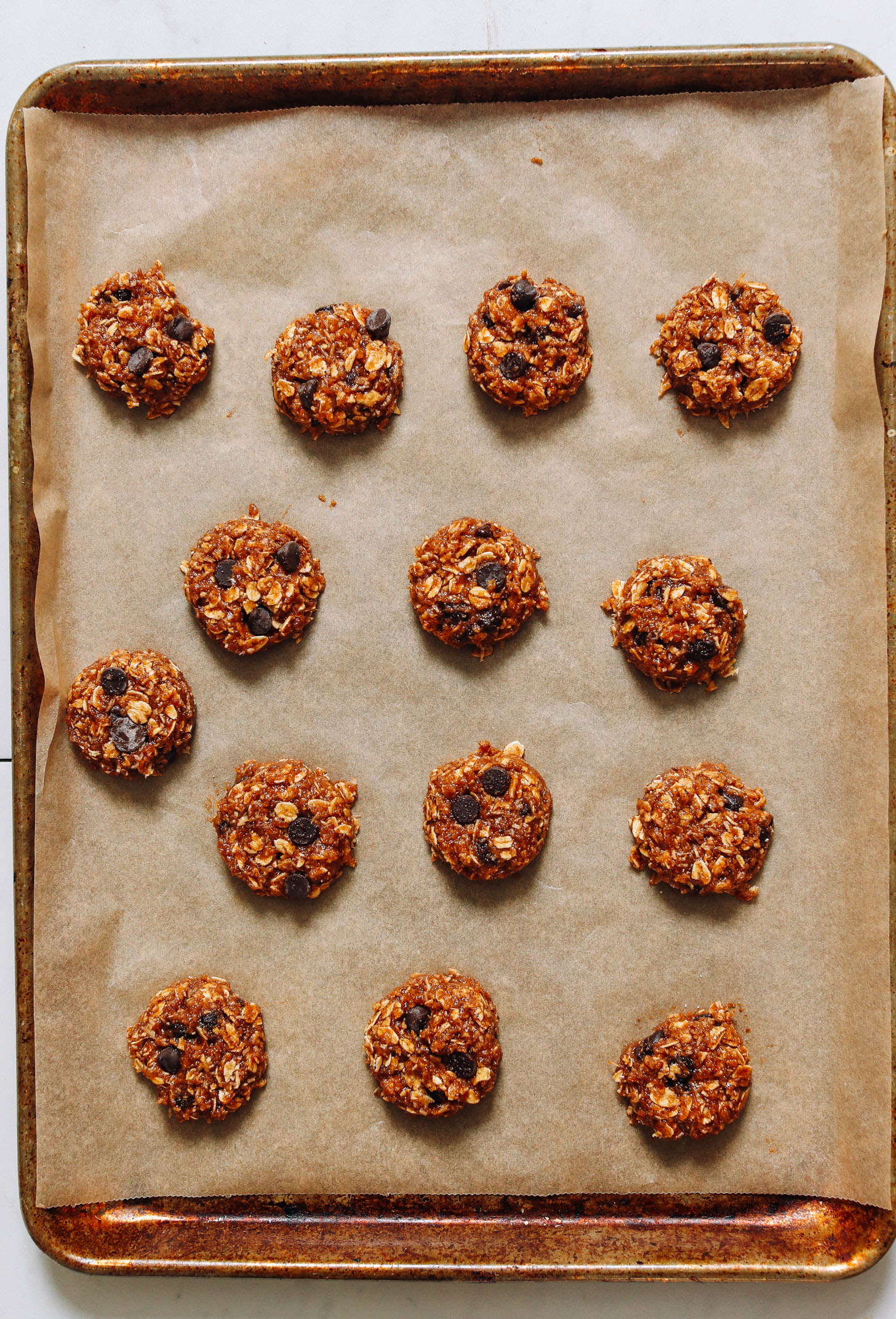 Parchment-lined baking sheet with Pumpkin Chocolate Chip Cookies ready to be baked