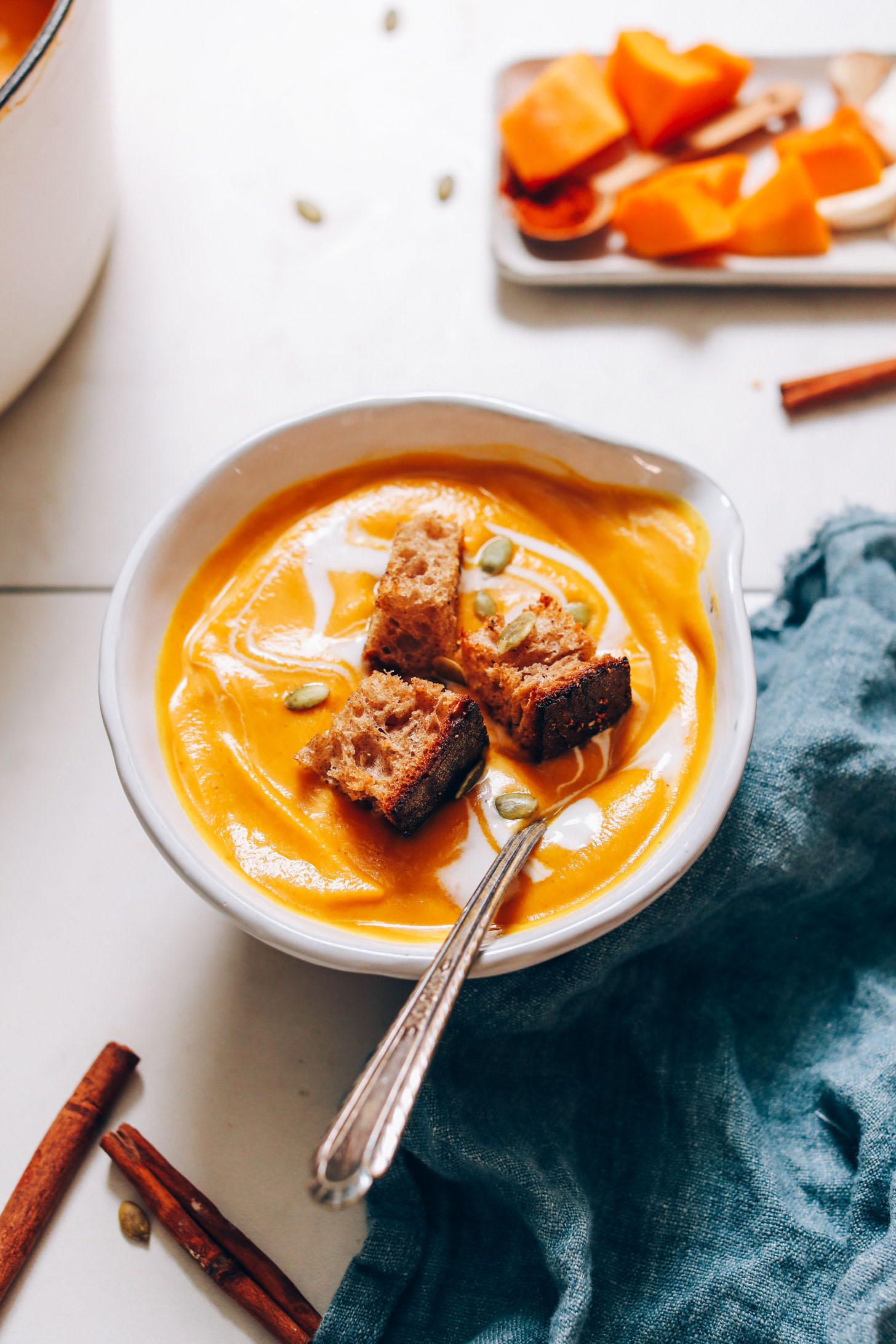 Croutons and pepitas on a bowl of roasted butternut squash soup