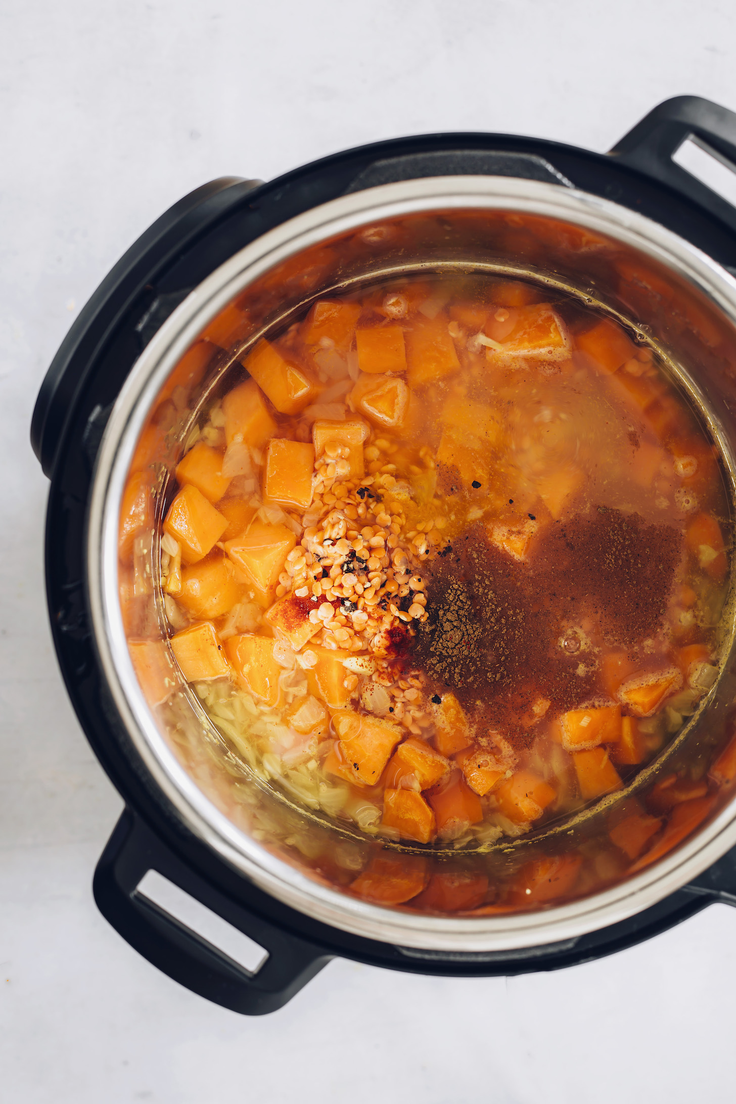 Red lentils, sweet potato, vegetable broth, water, and spices in an Instant Pot