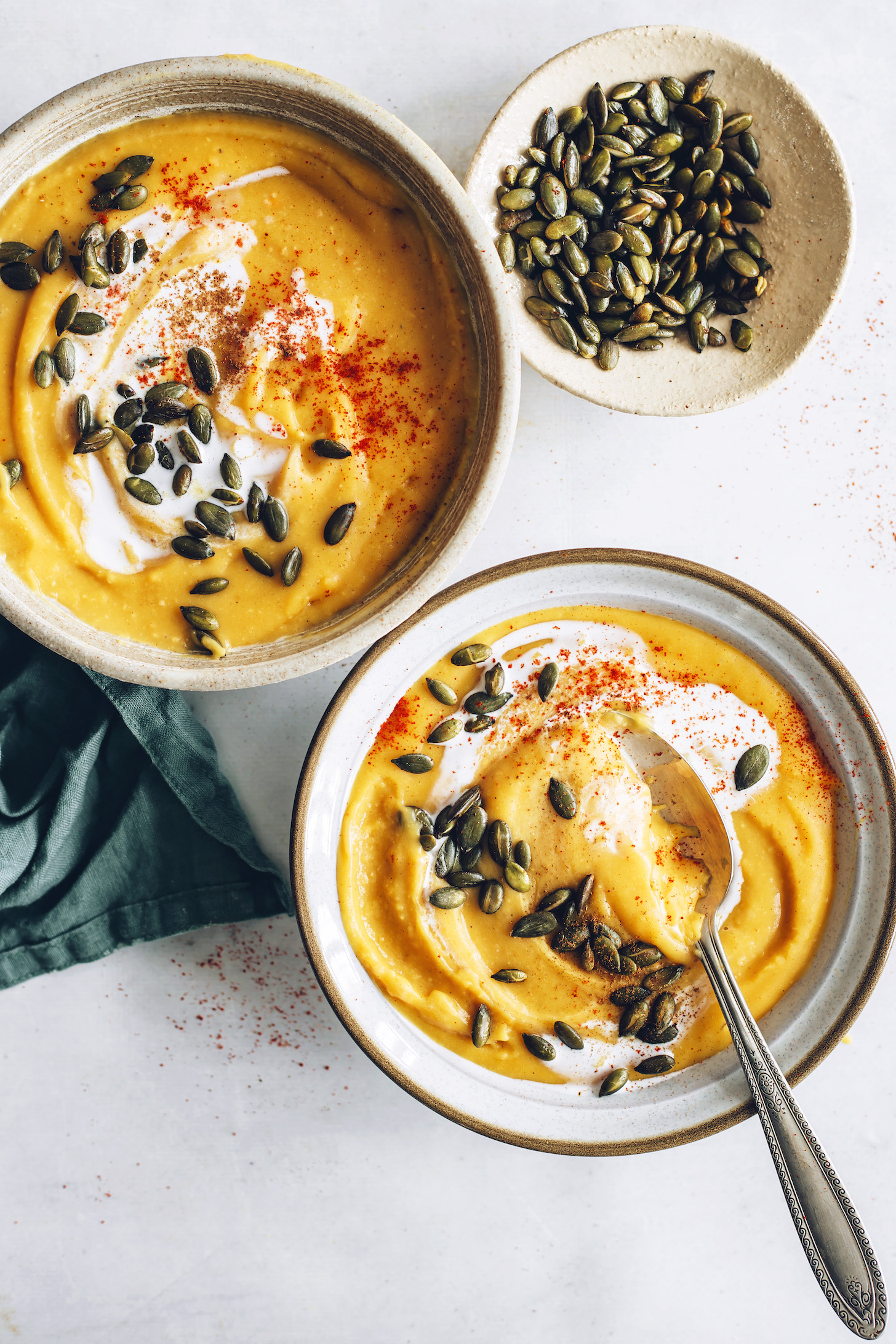 Bowls of pepitas and creamy sweet potato soup