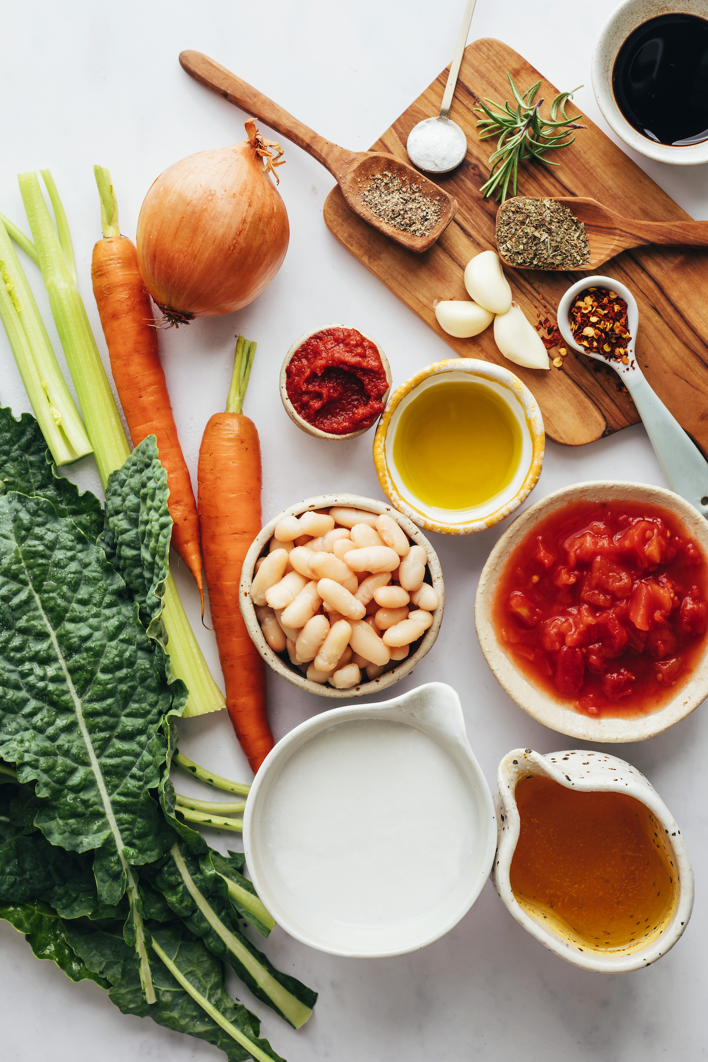 Onion, carrots, celery, kale, coconut milk, vegetable broth, tomatoes, white beans, olive oil, tomato paste, red pepper flakes, dried Italian herbs, garlic, salt, pepper, rosemary, and balsamic vinegar