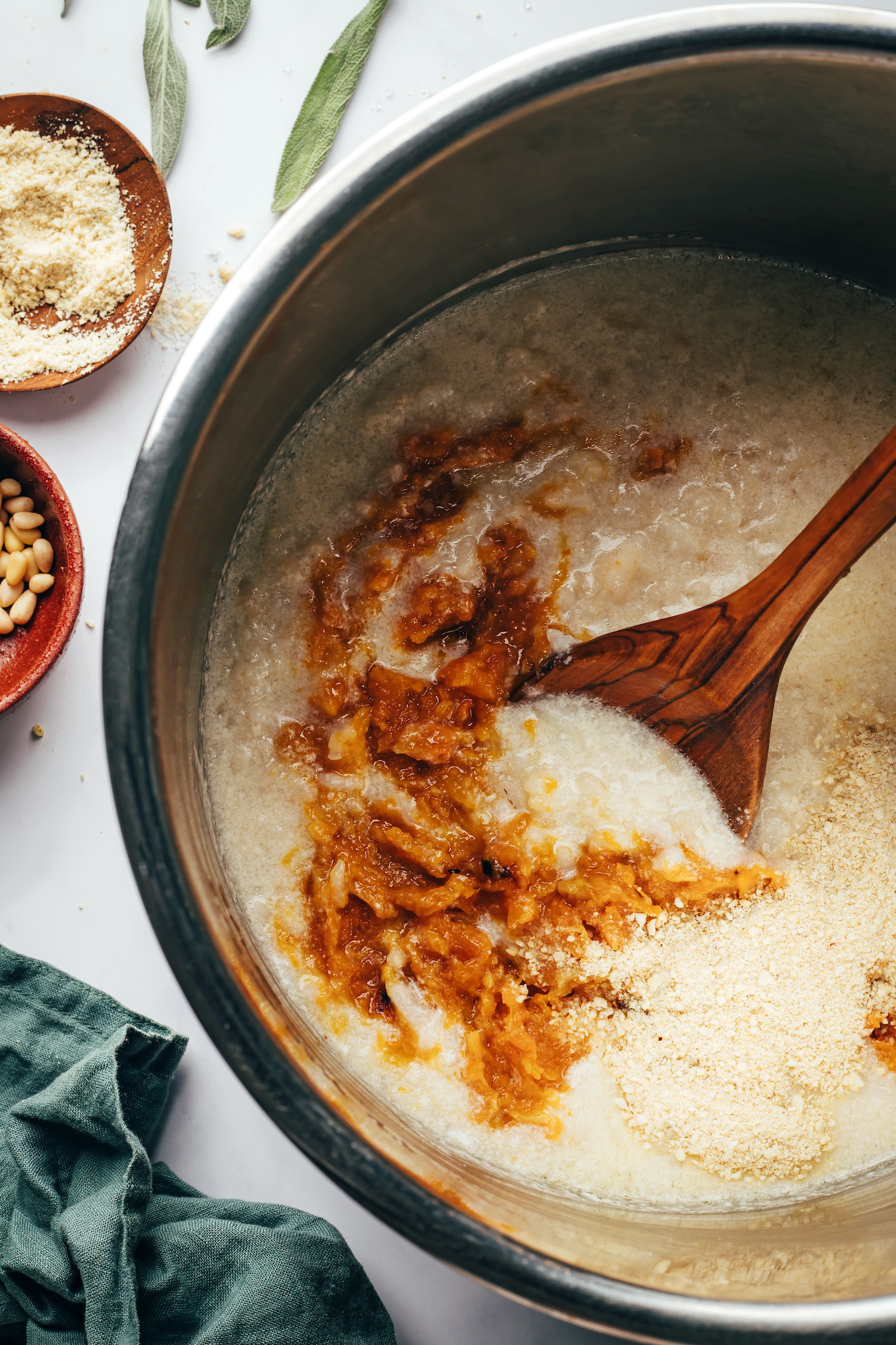 Stirring caramelized roasted butternut squash and garlic into a pot of risotto