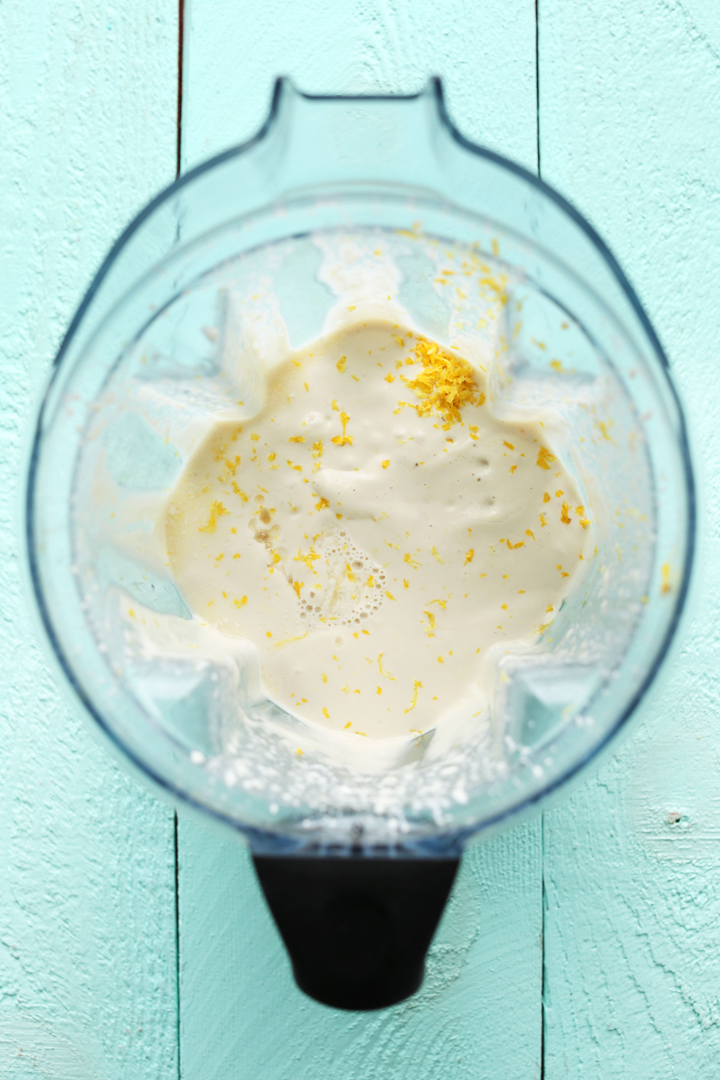 Blender with ingredients for making our creamy homemade vegan lemon bars