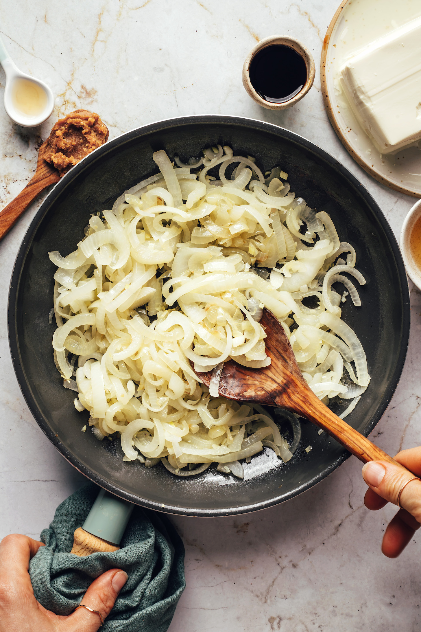 Sautéing sliced onions in a skillet