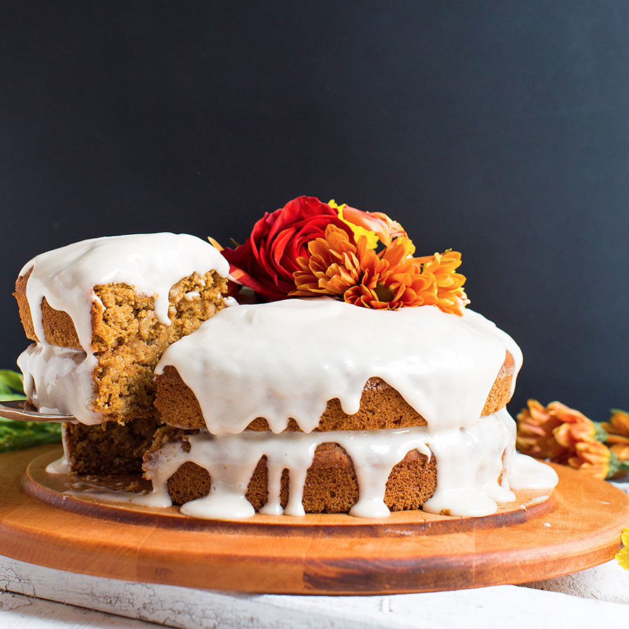 Removing a slice of gluten-free vegan Pumpkin Cake from a cutting board