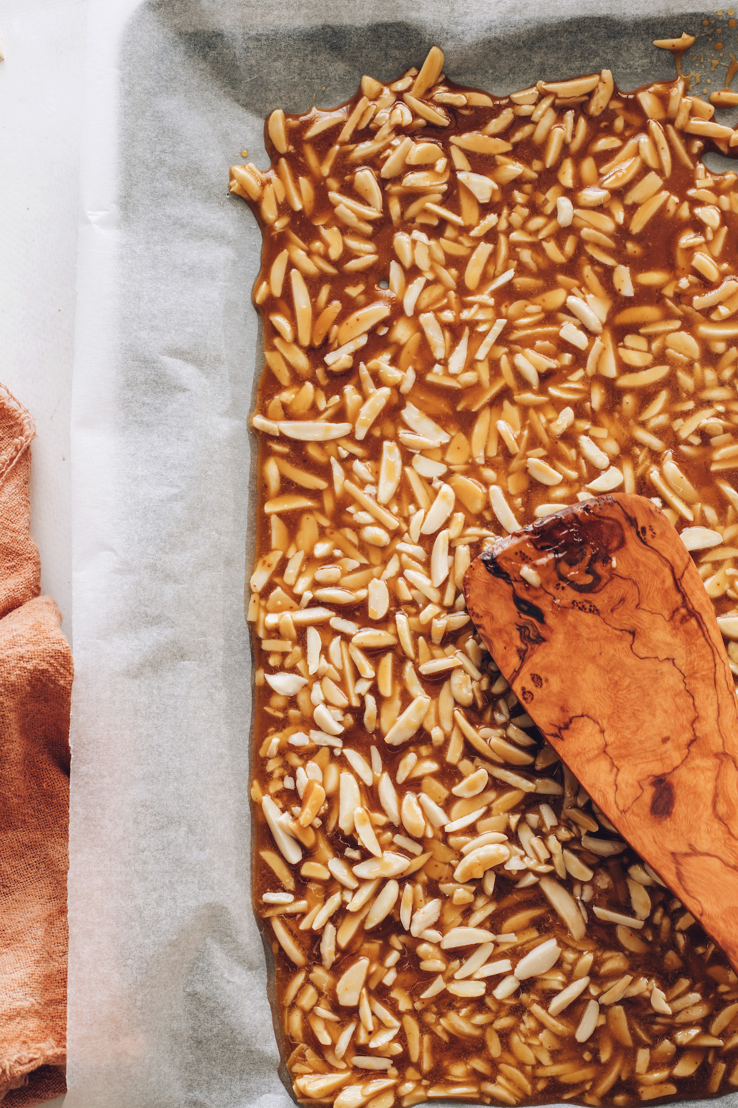 Spreading almond and caramelized sugar mixture on a baking sheet