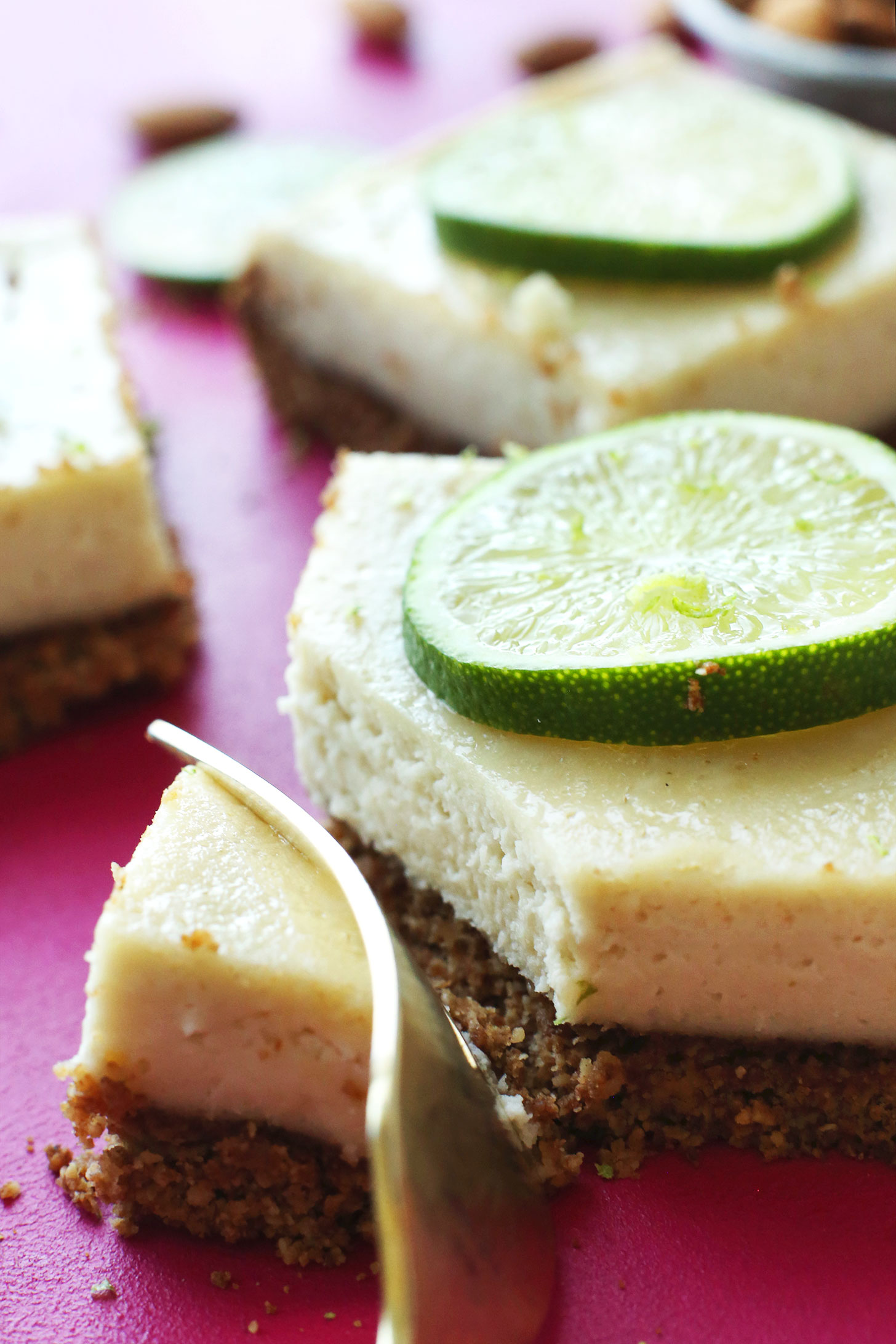 Slicing into a gluten-free vegan Key Lime Pie Bar for dessert