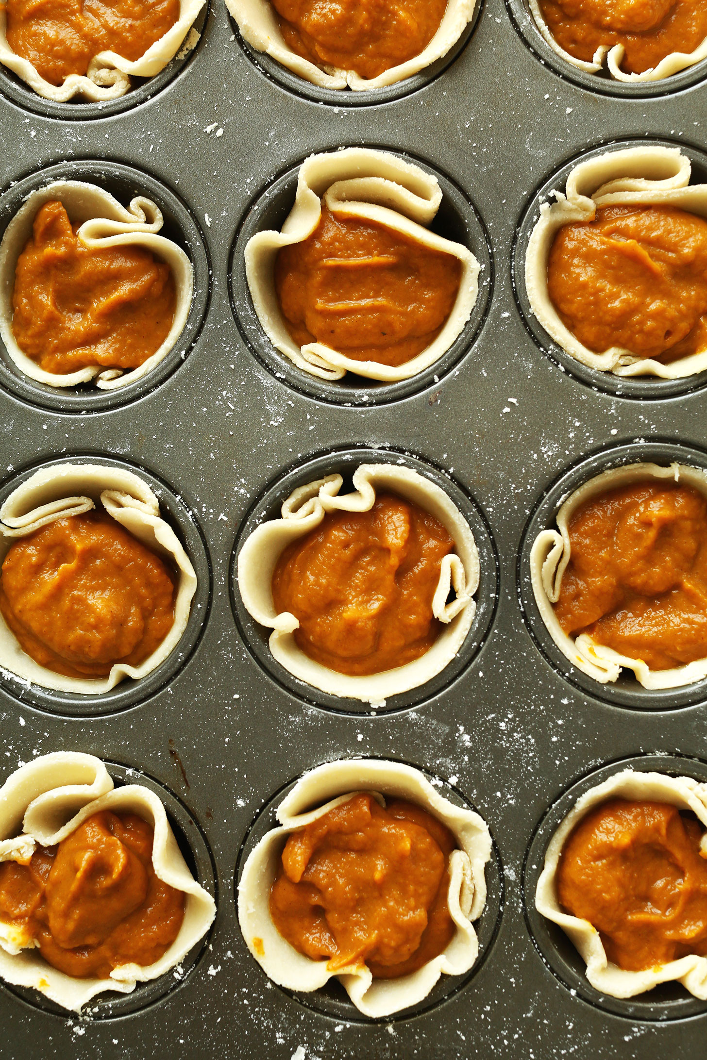 Pie pan of Mini Vegan Pumpkin Pies made with Coconut Oil Crust