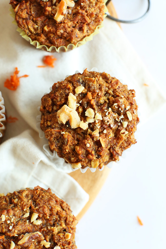 Gluten-free vegan Carrot Walnut Muffins resting on linens