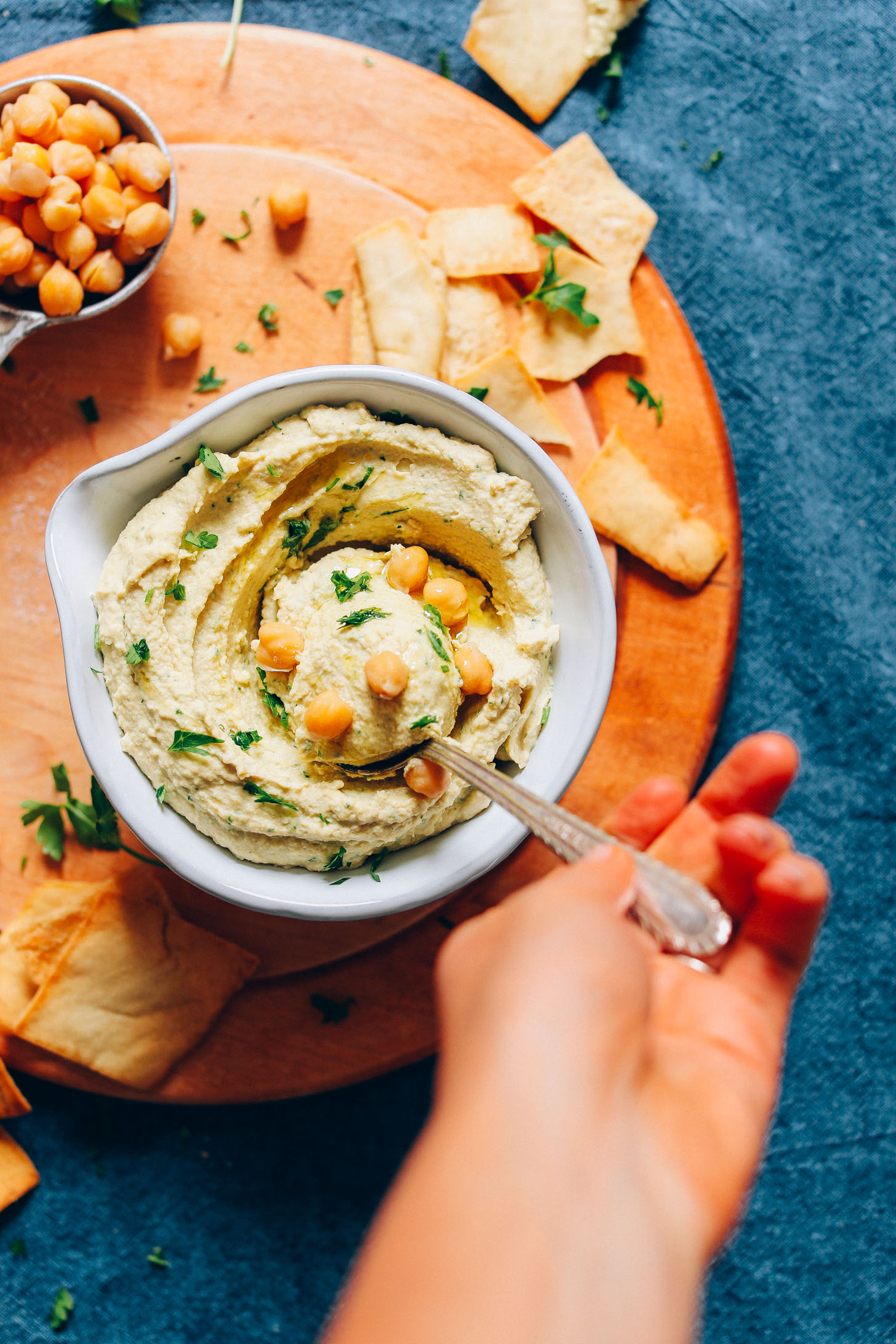 Scooping up a spoonful of fluffy perfect vegan hummus made from scratch