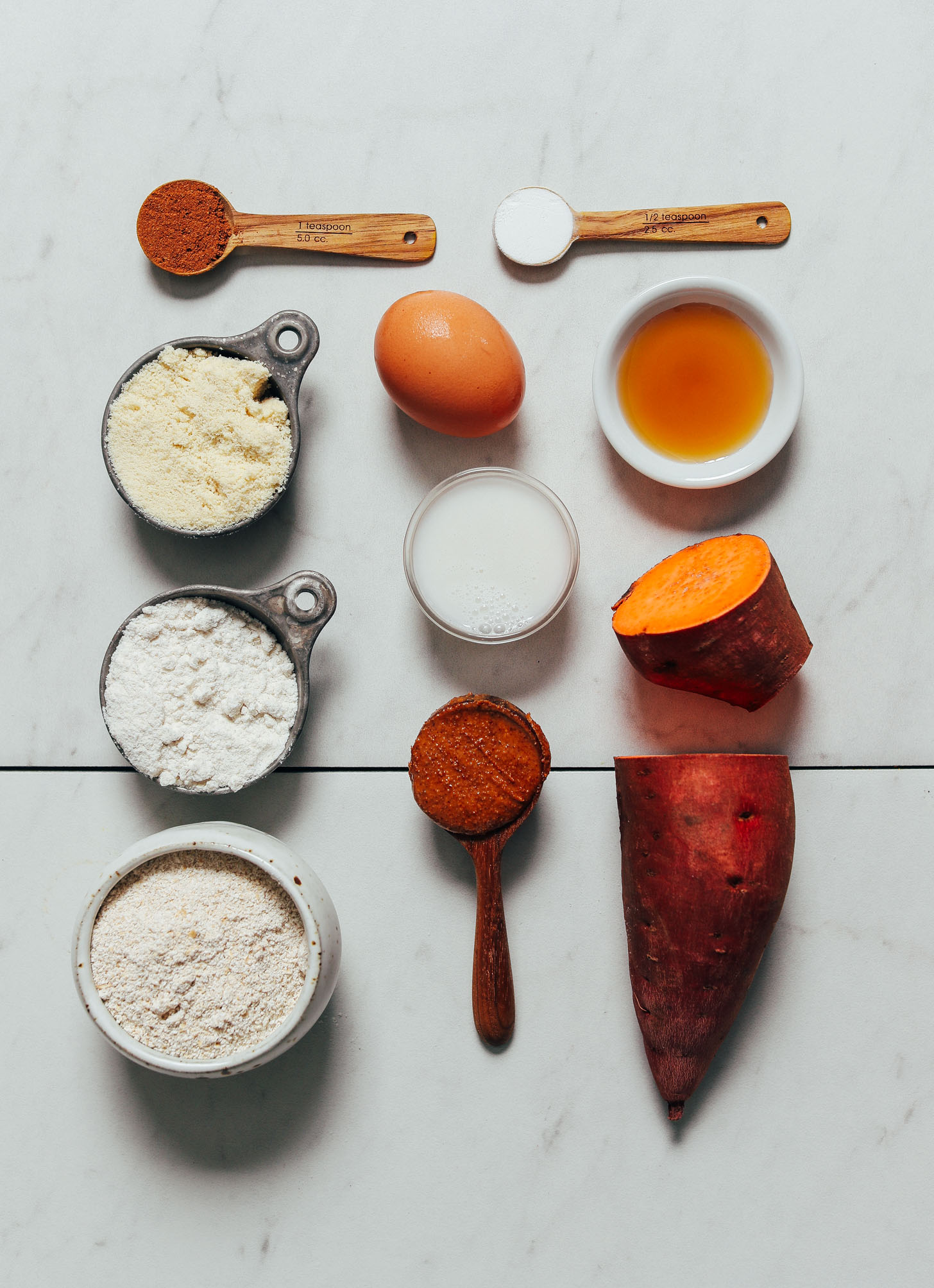 Sweet potato, egg, dairy-free milk, and other ingredients for making our Almond Butter Sweet Potato Muffins