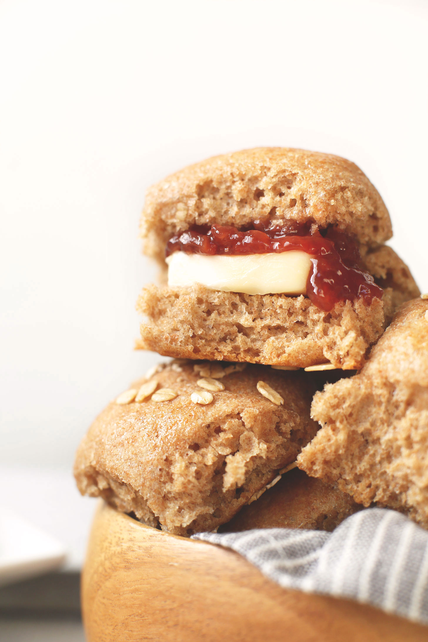 Pile of vegan Spelt Thanksgiving Dinner Rolls with vegan butter and jam