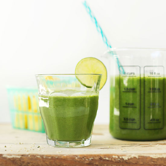 Measuring glass and drinking glass filled with our Ginger Colada Green Smoothie