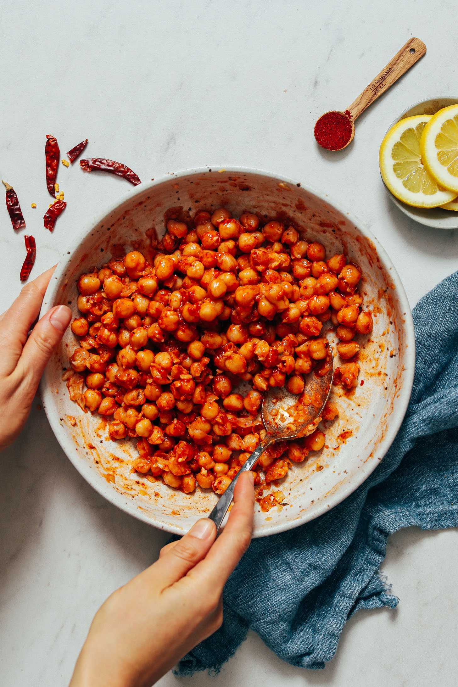 Holding a spoon and bowl of harissa chickpeas