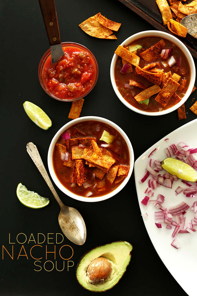 Two bowls of Loaded Nacho Soup with toppings for a delicious vegan meal