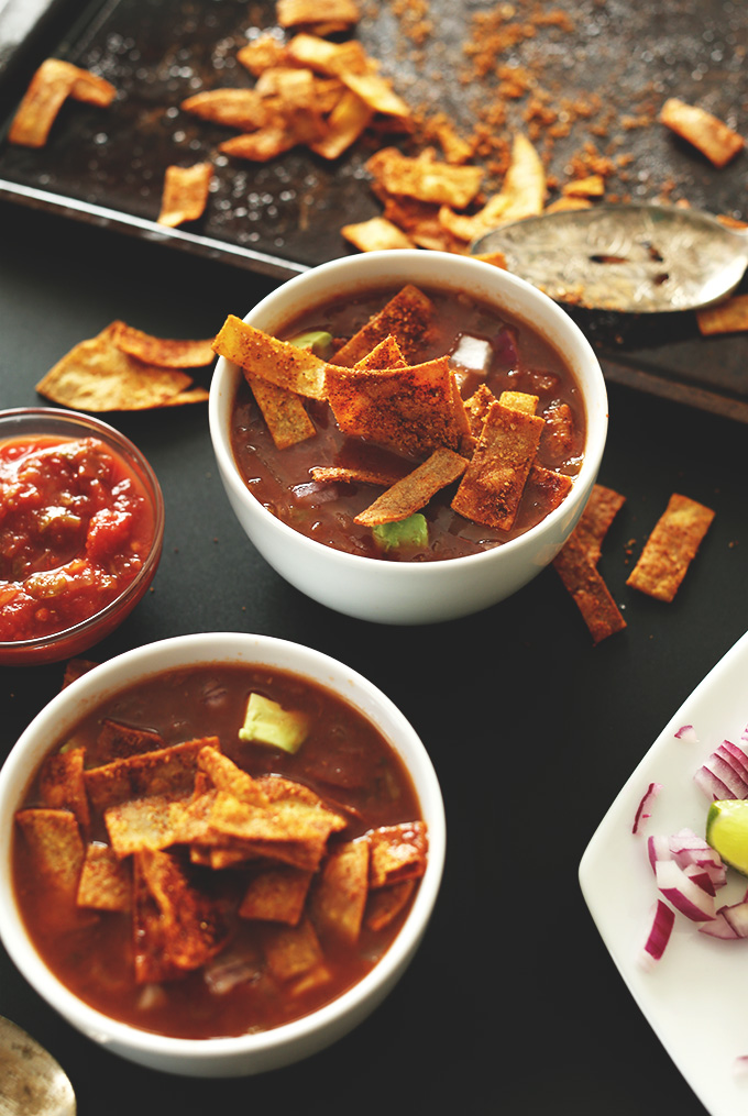 Bowls of Loaded Veggie Nacho Soup topped with DIY Chili Cheese Fritos