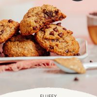 Spoonful of almond butter resting beside a tray of Banana Chocolate Chip Cookies