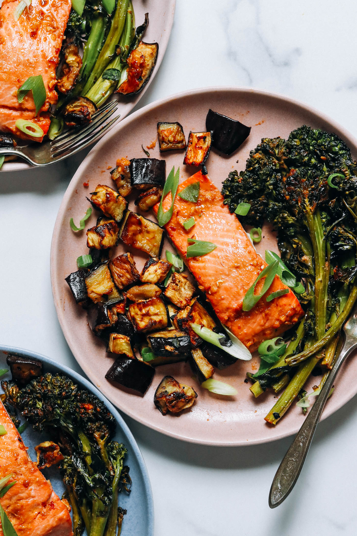 Plates of miso-glazed salmon and veggies