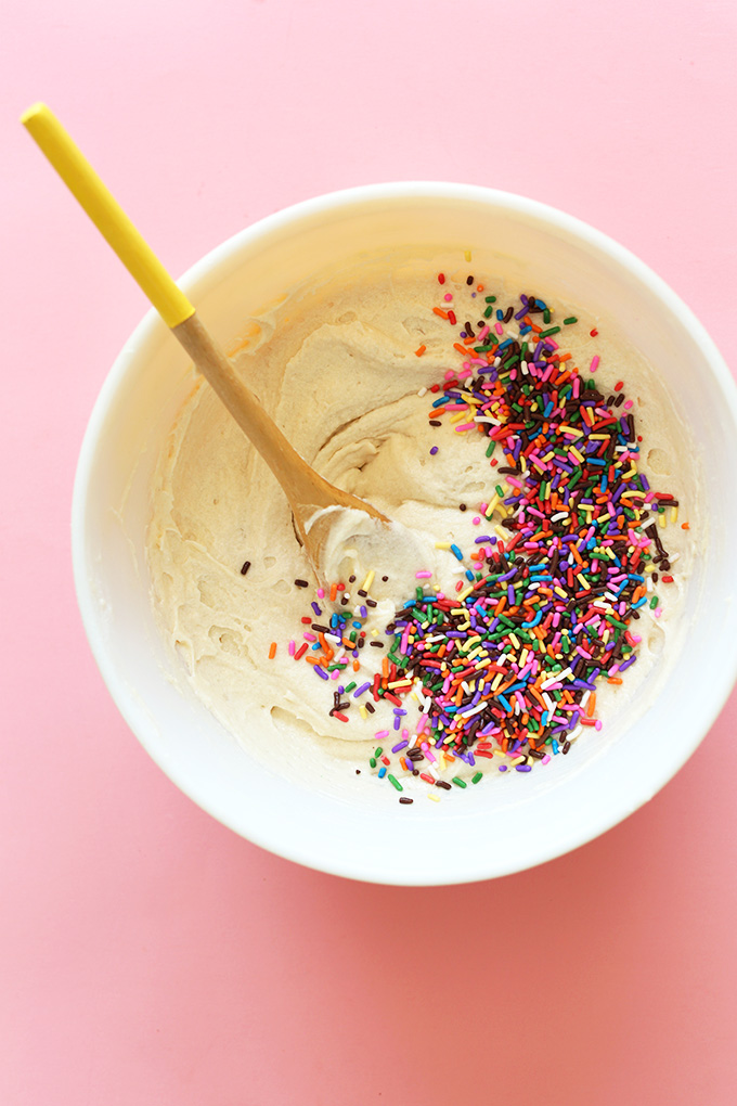 Stirring a bowl of batter for Vegan Funfetti Cupcakes