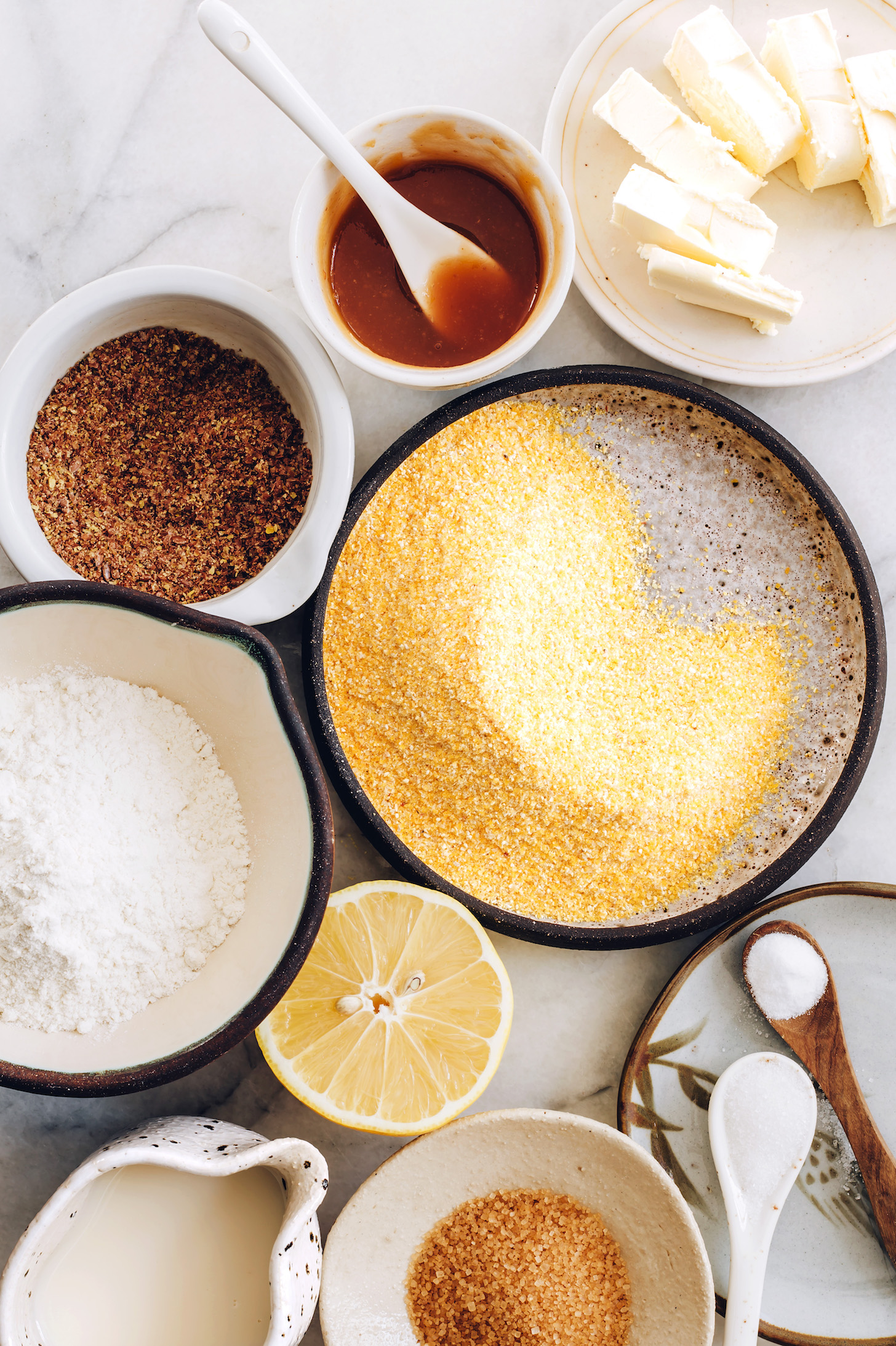 Cornmeal, flour, ground flax, lemon, almond milk, vegan butter, applesauce, salt, baking soda, and sugar