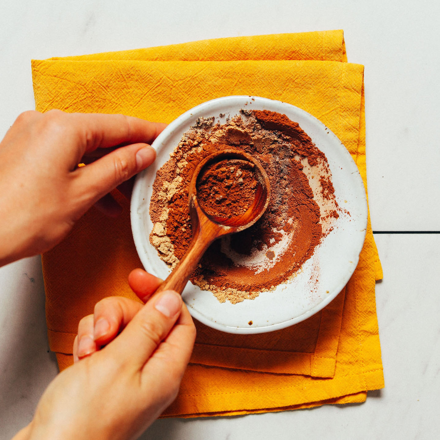 Scooping up homemade Pumpkin Pie Spice from a bowl