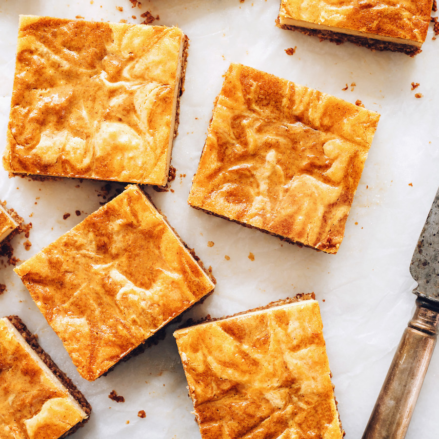 Close up shot of squares of pumpkin swirl cheesecake