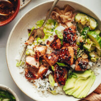 Salmon sushi bowl with cucumber salad, rice, and salmon