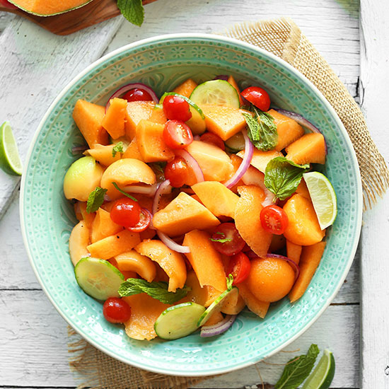 Teal bowl filled with our Summer Tomato, Cucumber, and Cantaloupe Salad