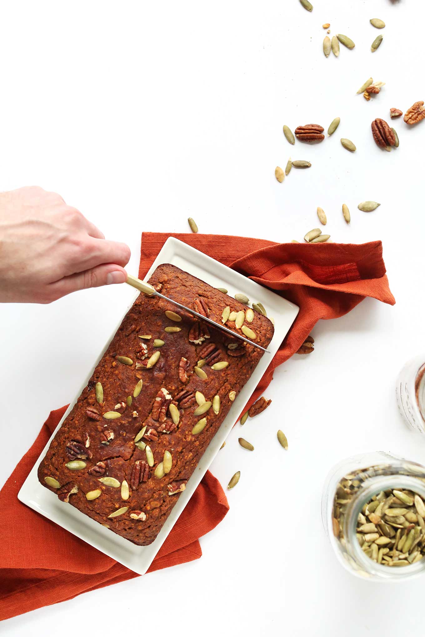 Slicing into a loaf of Vegan Gluten-Free Pumpkin Bread