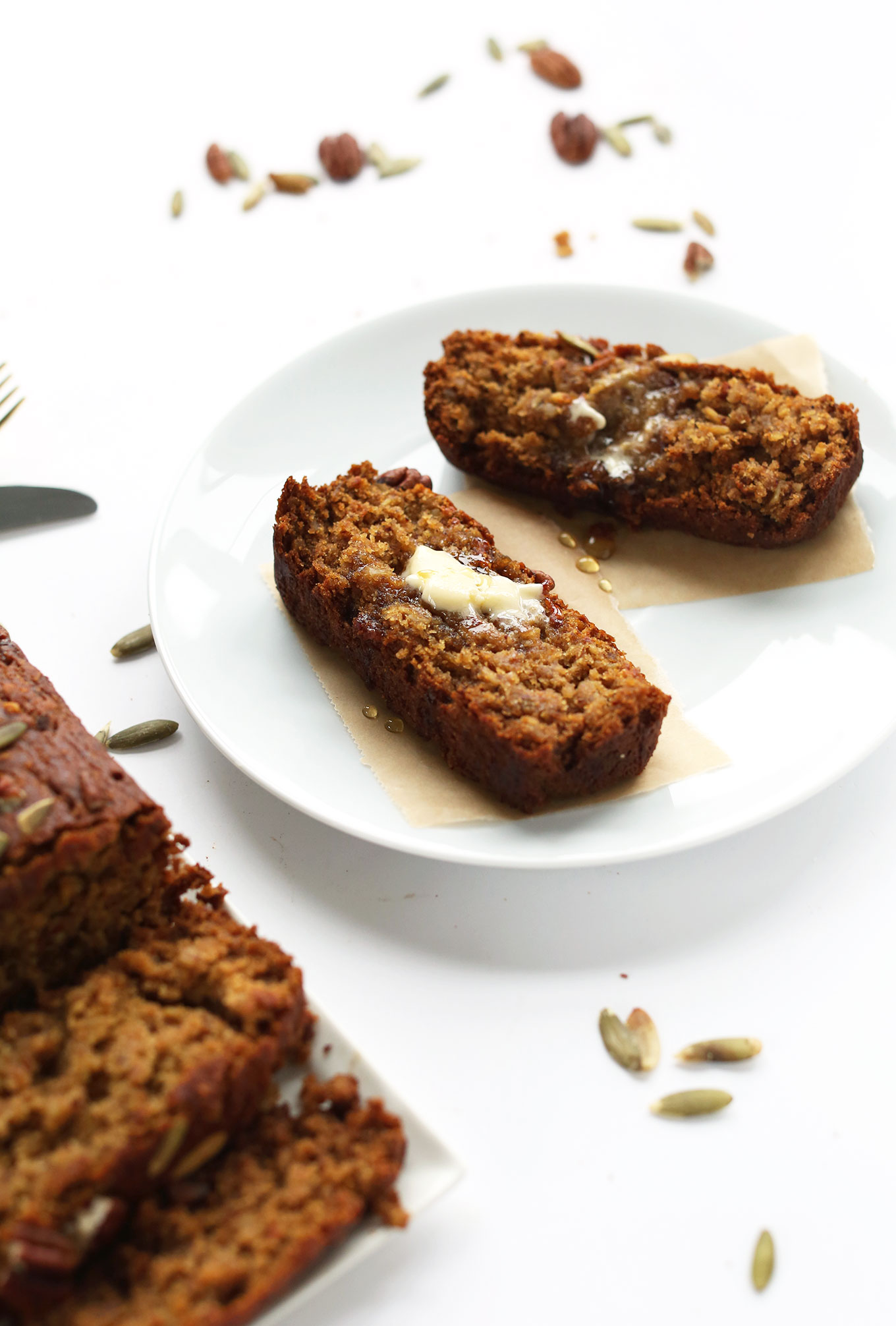 Plate with slices of Gluten-Free Vegan Pumpkin Bread topped with syrup and vegan butter