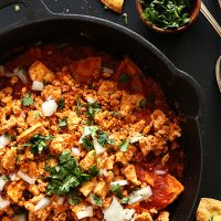 Cast iron skillet filled with Tofu Chilaquiles