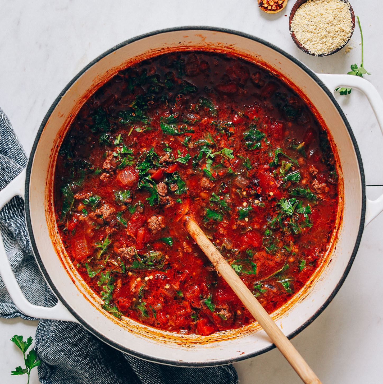 Wooden spoon in a big pot of Tuscan Beef Soup with Lentils