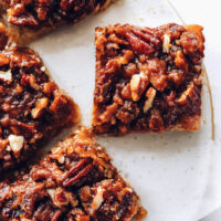 Decadent pecan pie bars on a ceramic tray