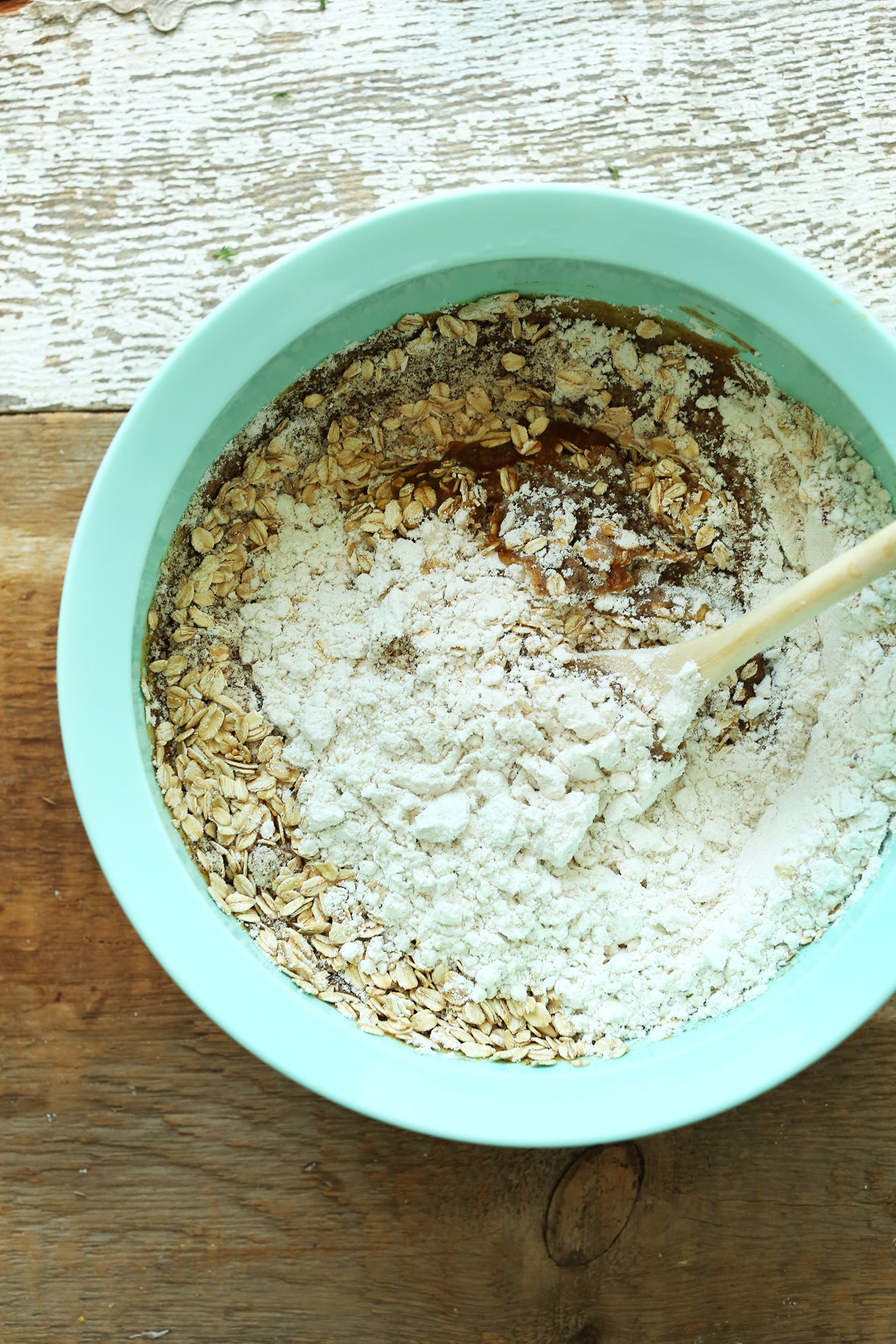 Stirring wet and dry ingredients together for our gluten-free vegan Pumpkin Spice Muffins recipe