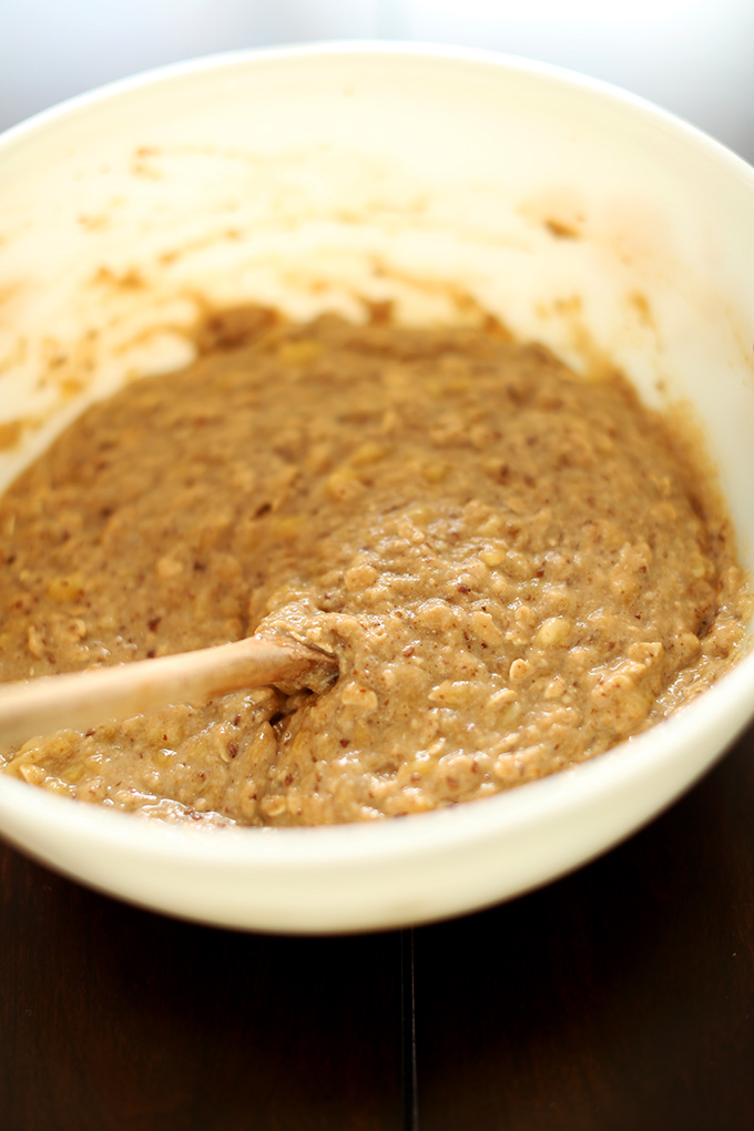 Using a wooden spoon to stir Vegan Banana Crumble Muffin batter