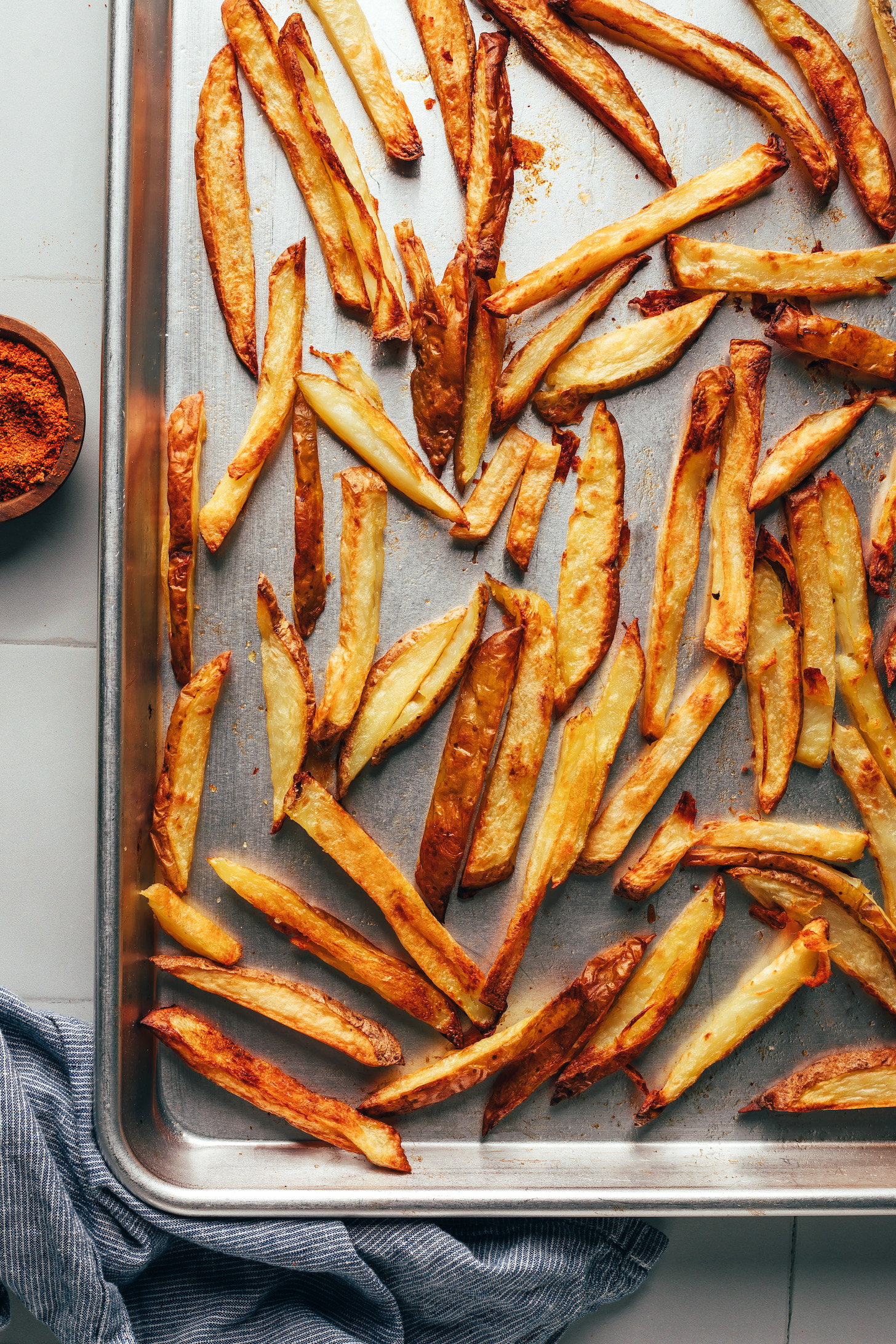 Homemade potato fries on a baking sheet