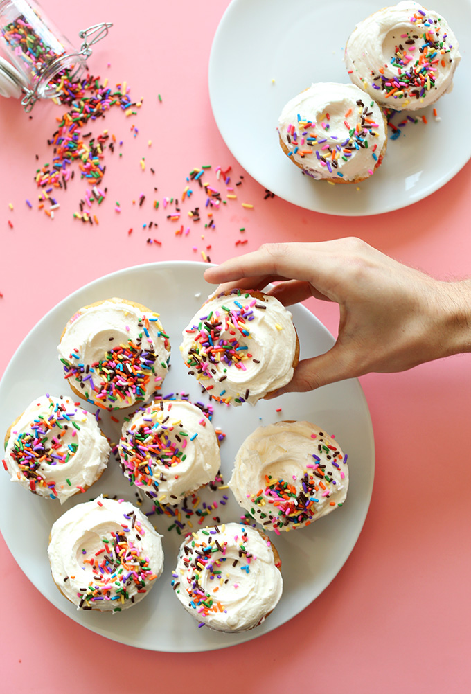 Holding up a Vegan Funfetti Cupcake from a plate