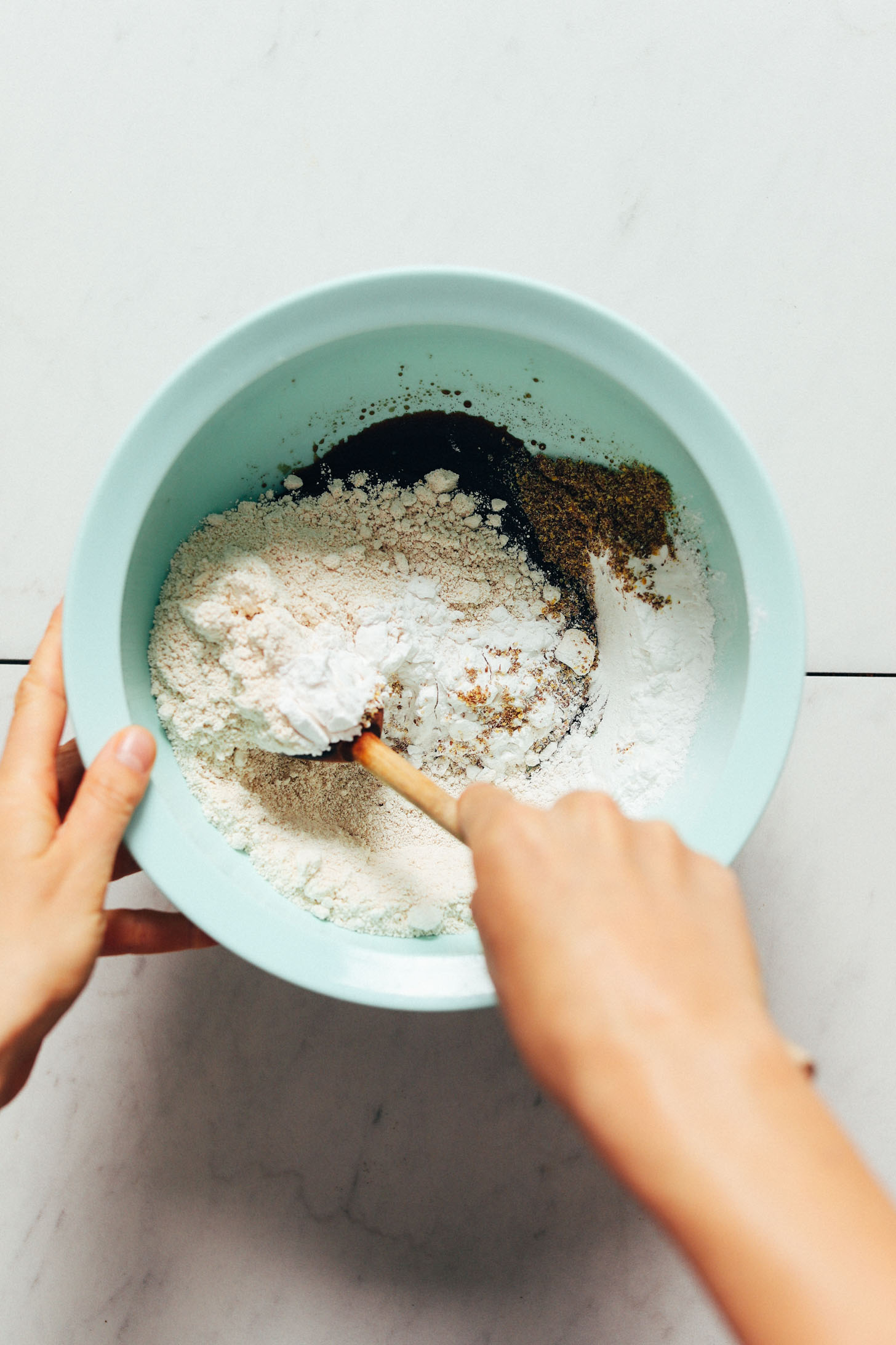 Stirring wet and dry ingredients in a mixing bowl